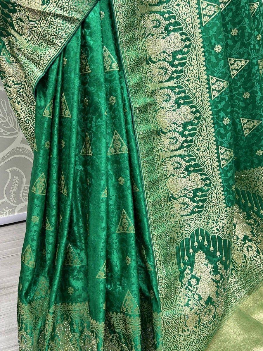 Emerald green designer saree with gold zari peacock motifs and temple border, perfect for weddings and festivals.