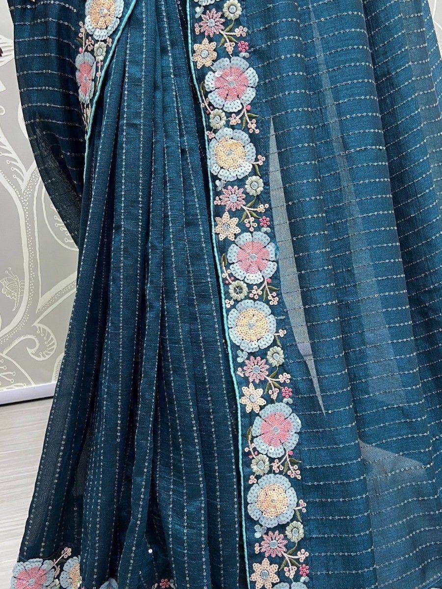 Blue ethnic saree with floral embroidery and delicate threadwork detailing
