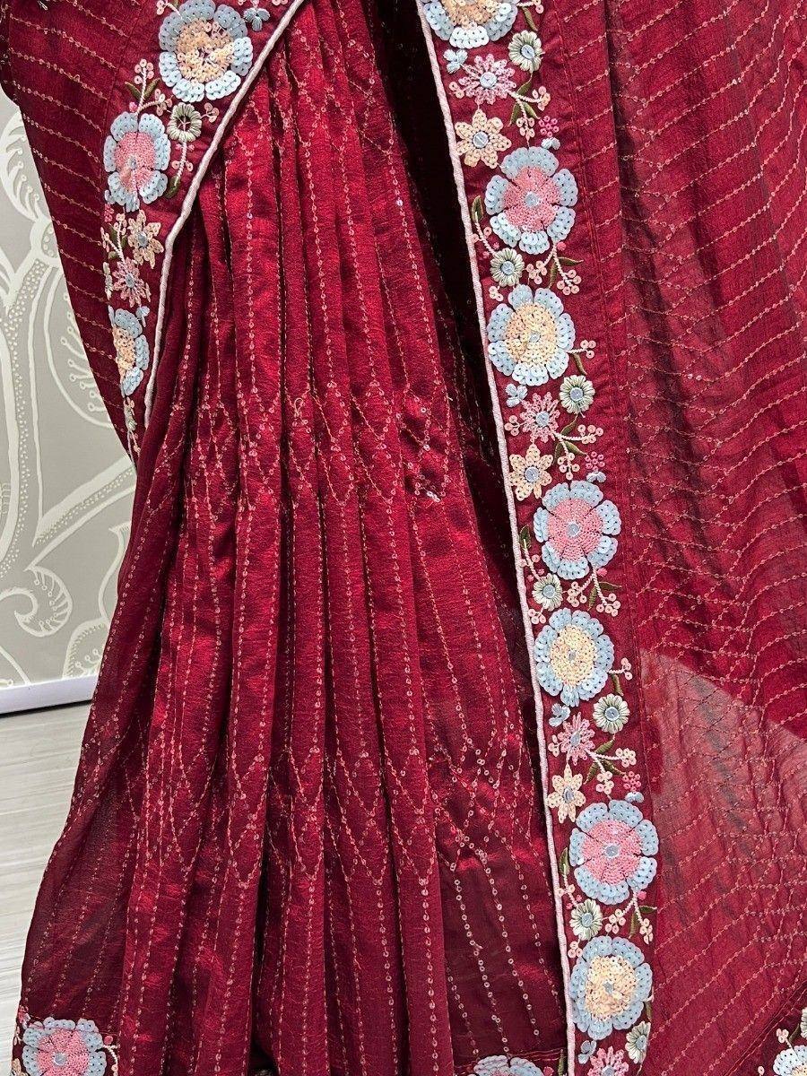 Maroon ethnic saree with floral embroidery and sequin detailing, perfect for Indian occasions