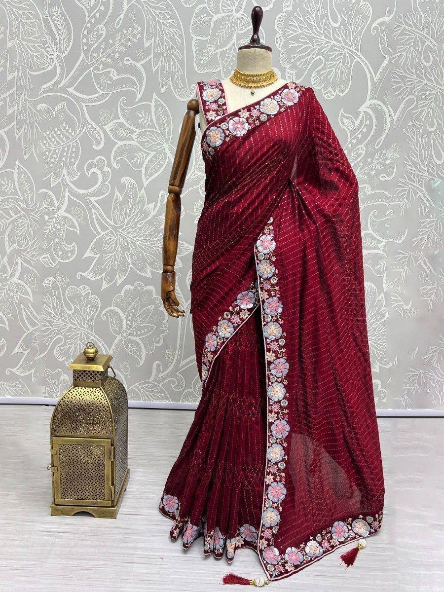Maroon embroidered saree with floral border, styled on mannequin for ethnic wear