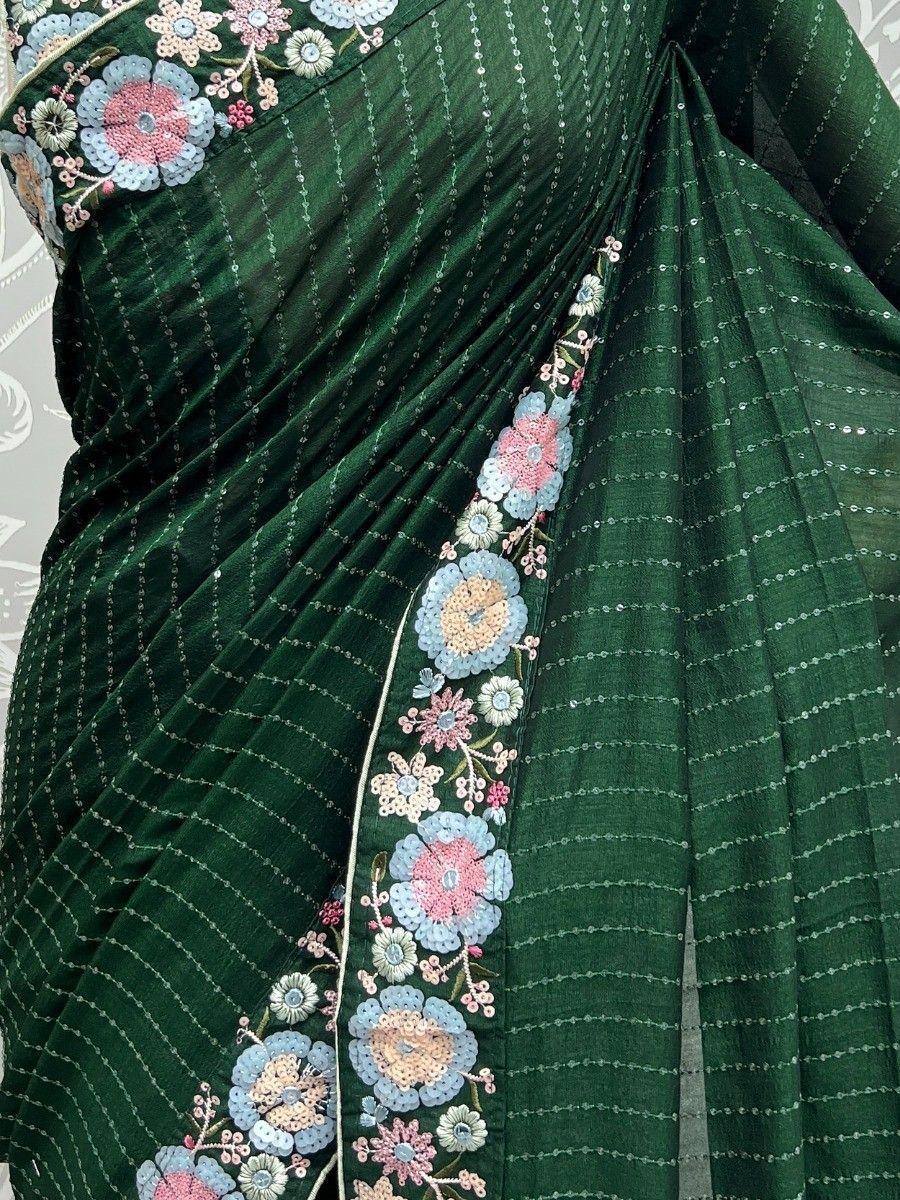 Emerald green saree with floral sequin embroidery and delicate border detailing