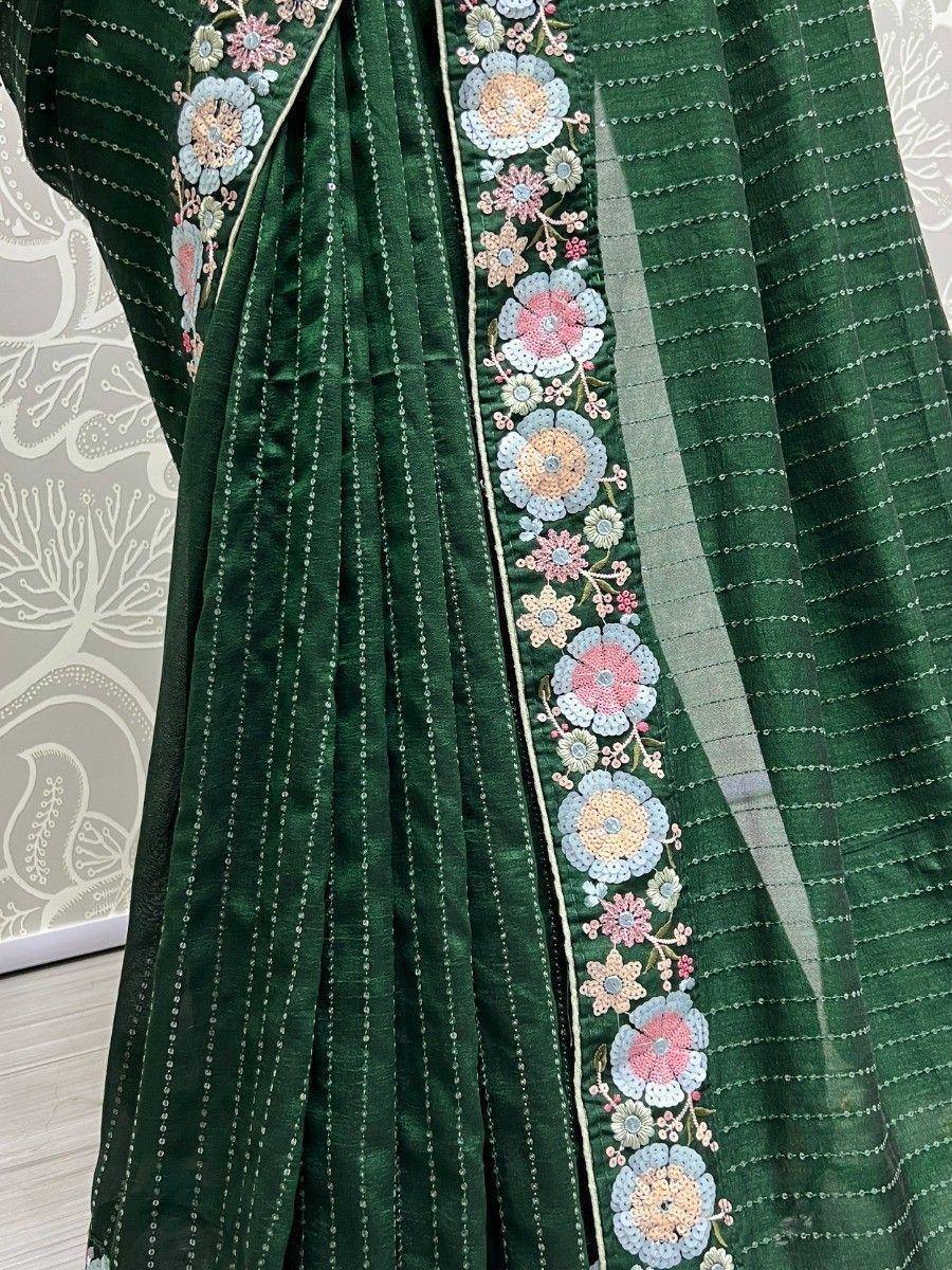 Green ethnic saree with floral embroidery and kantha stitch detailing, perfect for Indian occasions