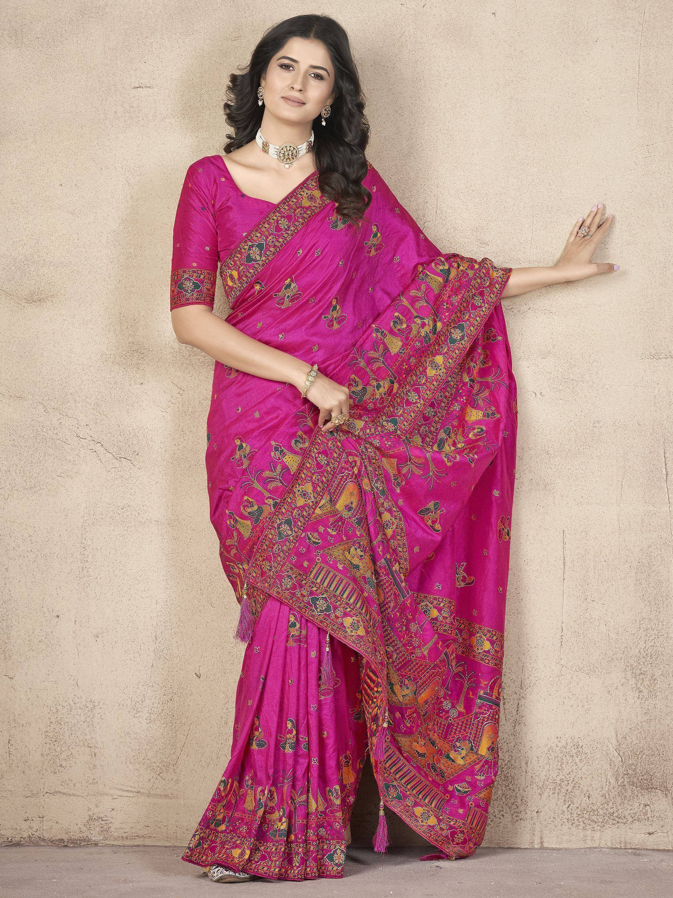 Vibrant pink ethnic saree with intricate gold and multicolor print, perfect for festive occasions.
