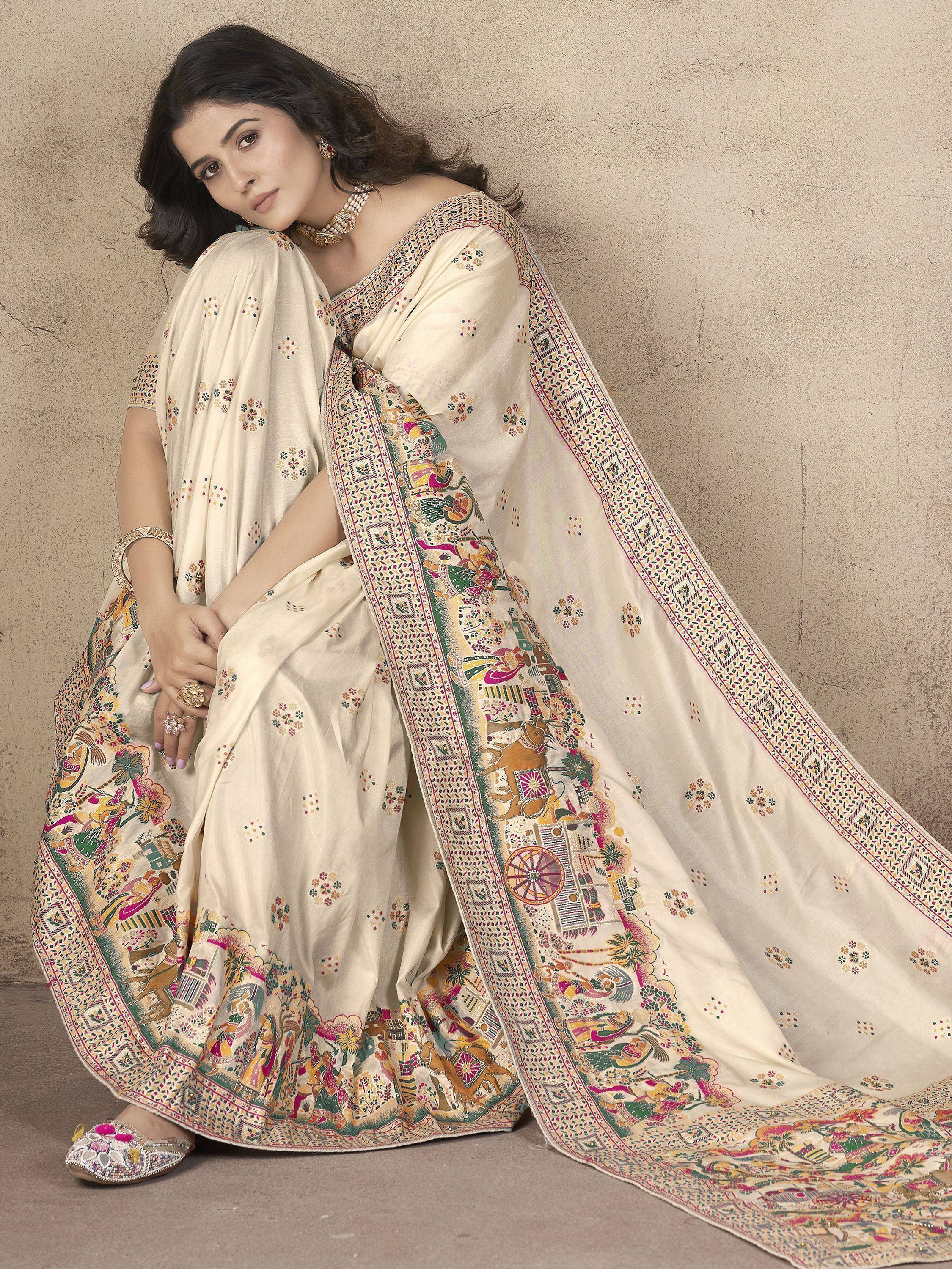 Cream ethnic saree with colorful folk art print, perfect for Indian occasions and festivals.