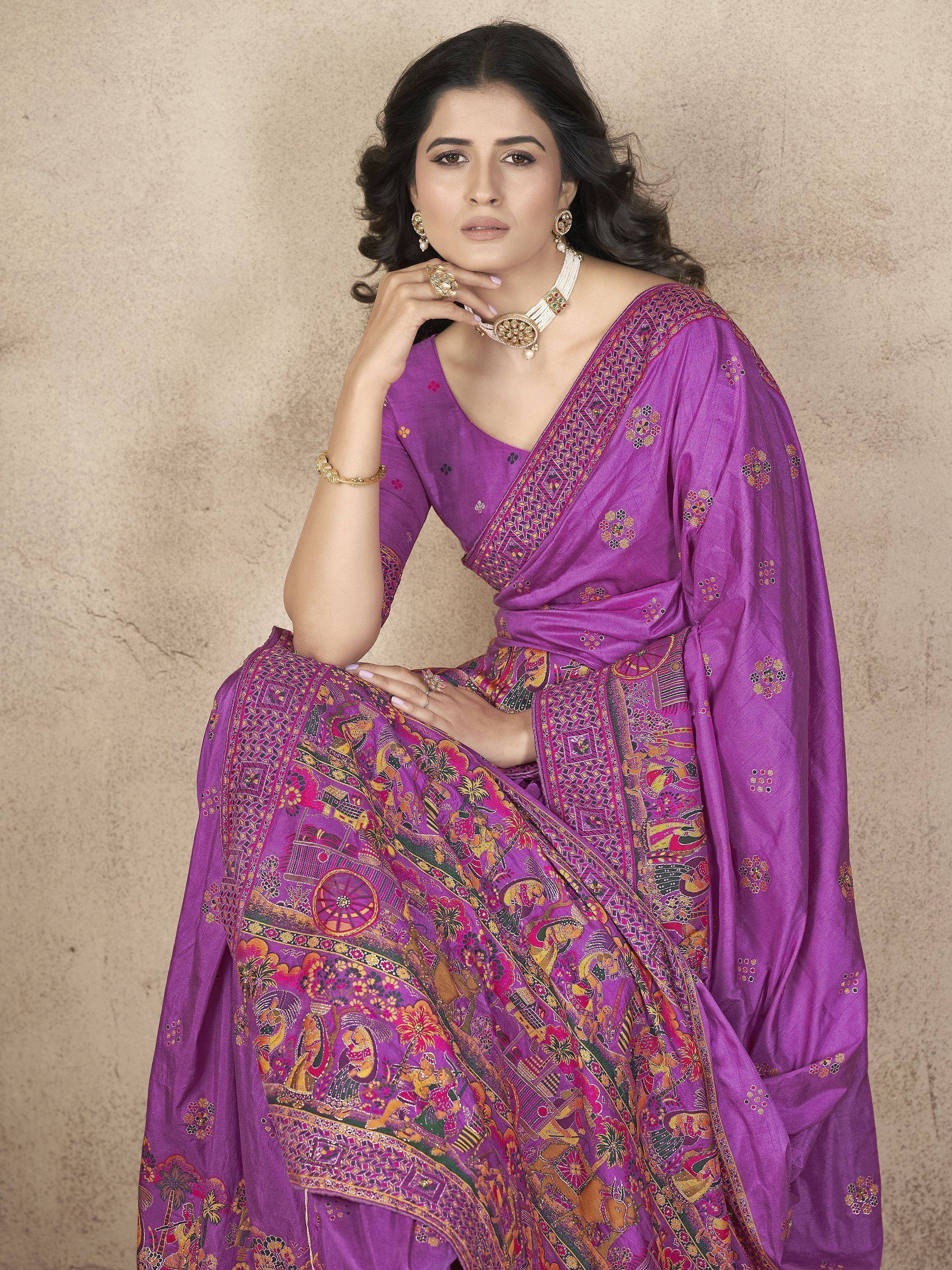 Purple printed saree with intricate ethnic motifs and gold jewelry, perfect for traditional occasions