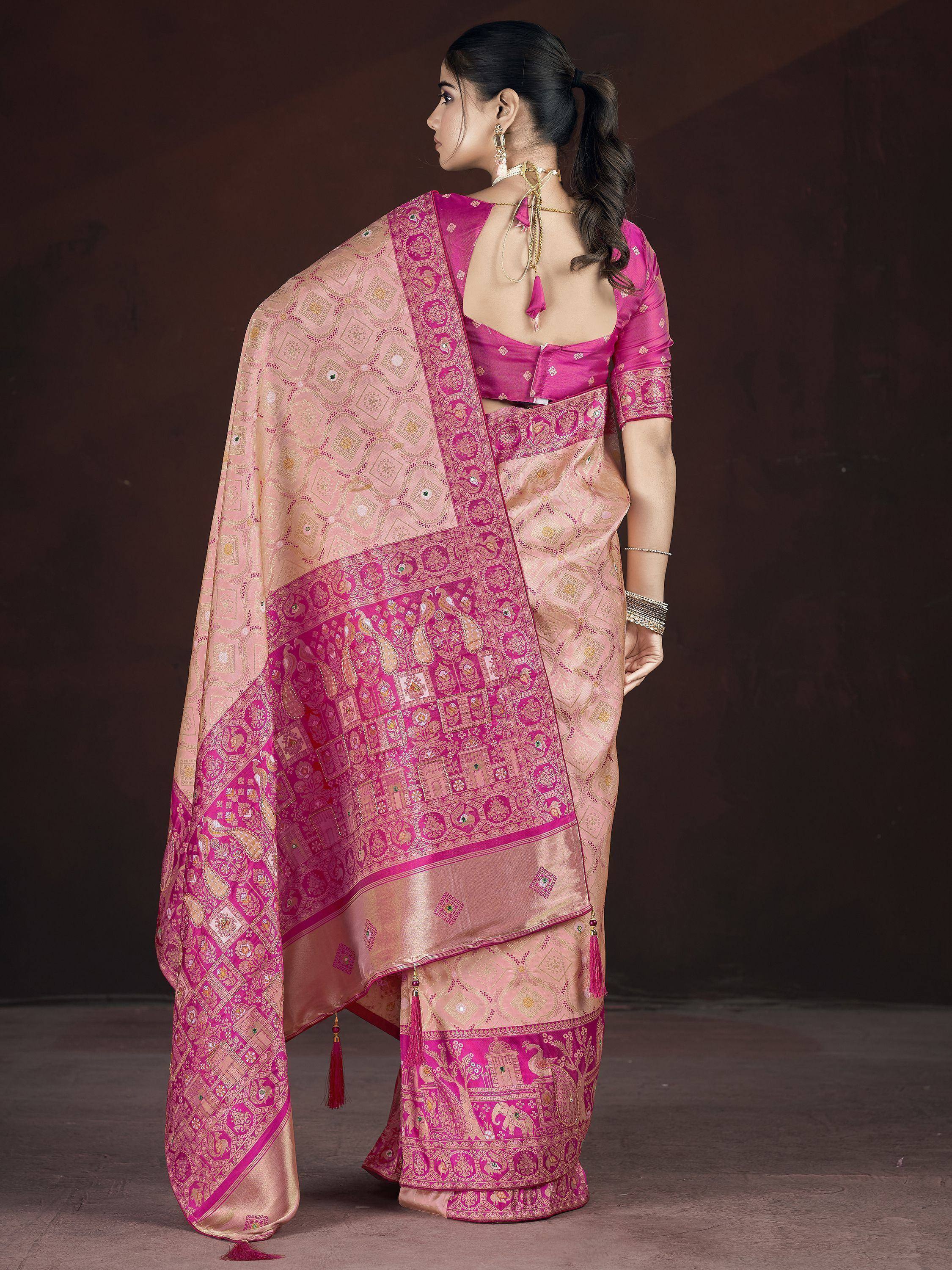 Pink and gold designer saree with intricate woven patterns and tassels, perfect for ethnic occasions