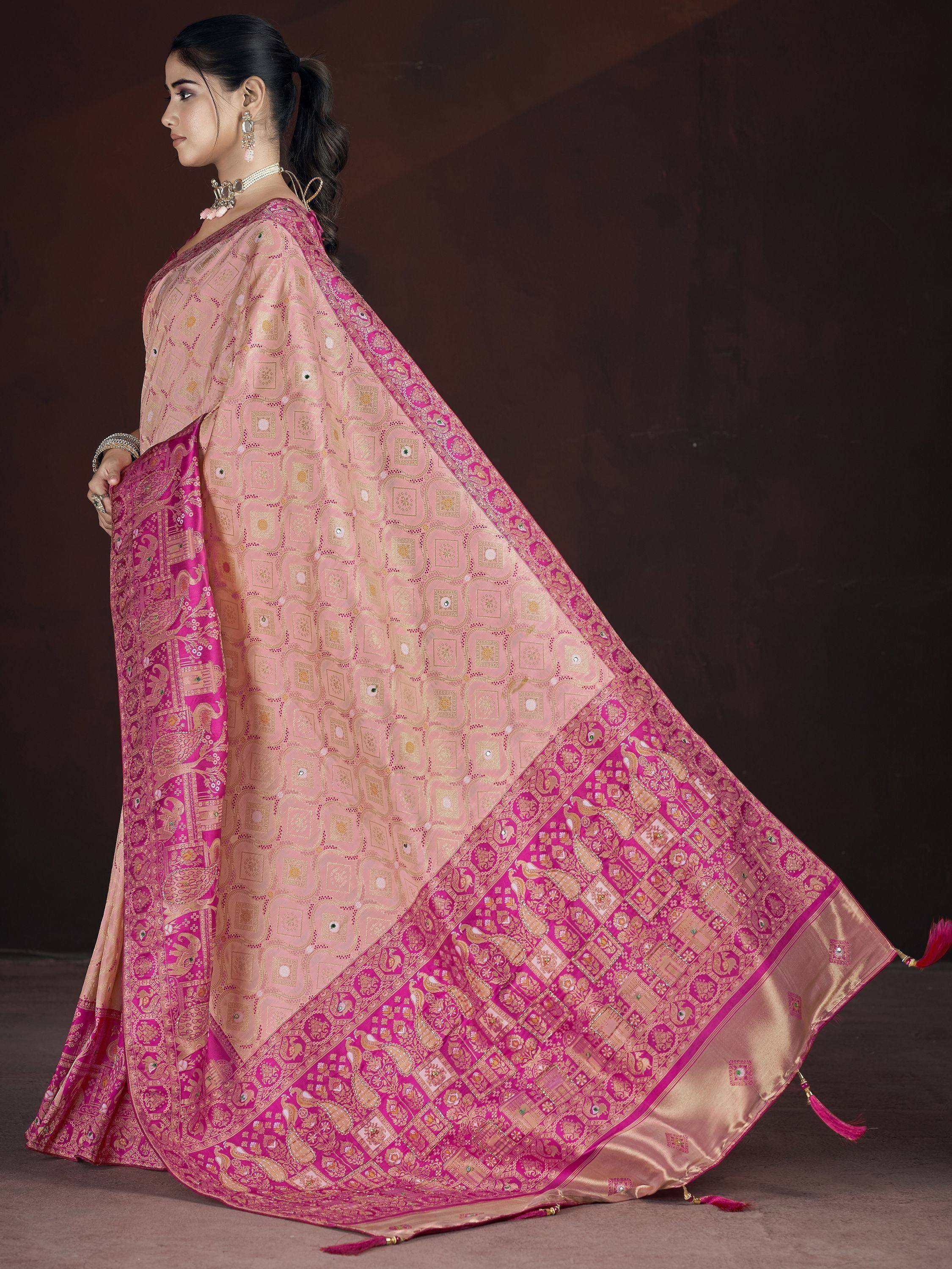 Pink and gold designer saree with intricate patterns and mirror work, perfect for ethnic occasions