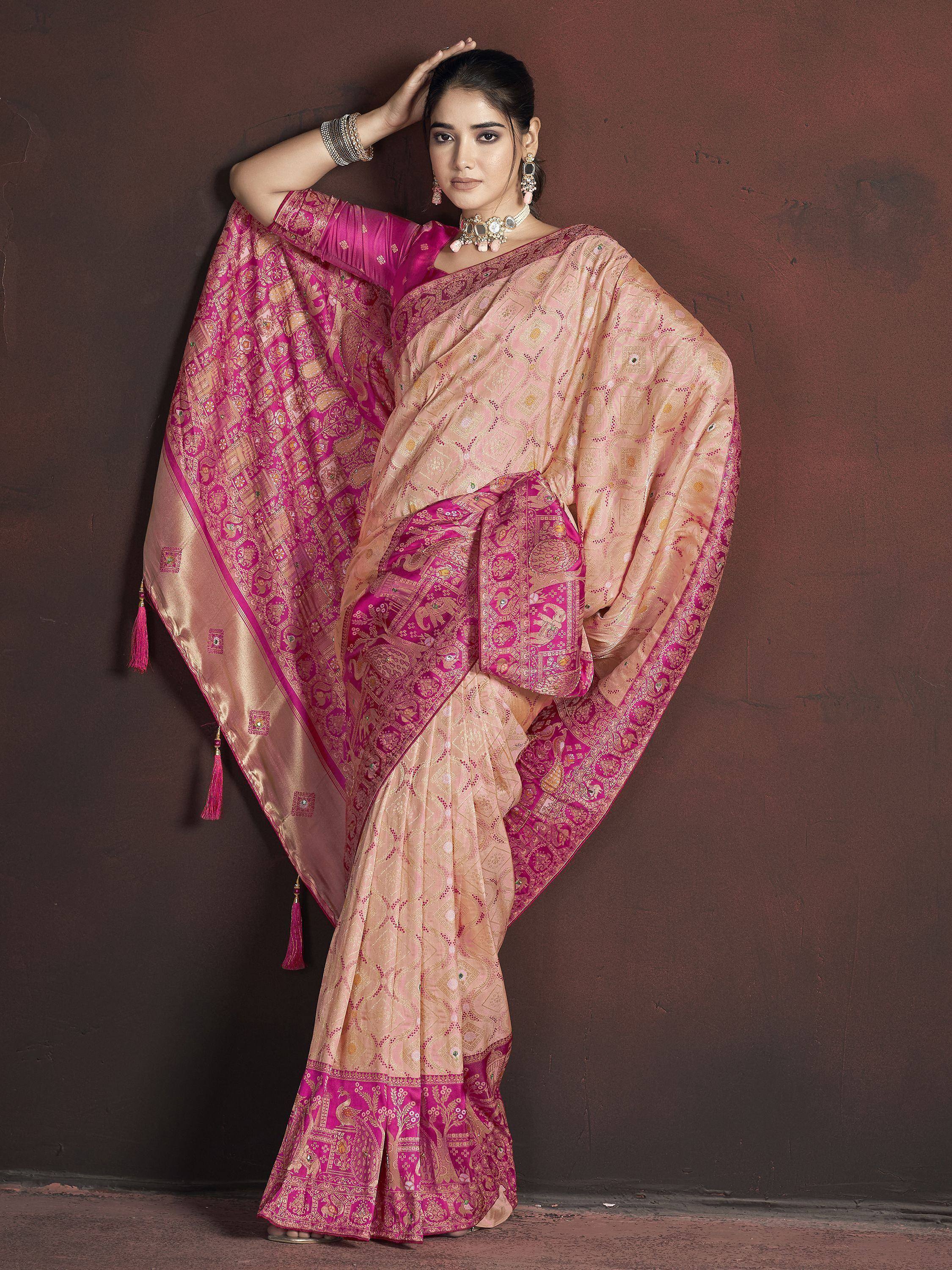 Pink and gold designer saree with intricate patterns and tassels, perfect for ethnic occasions