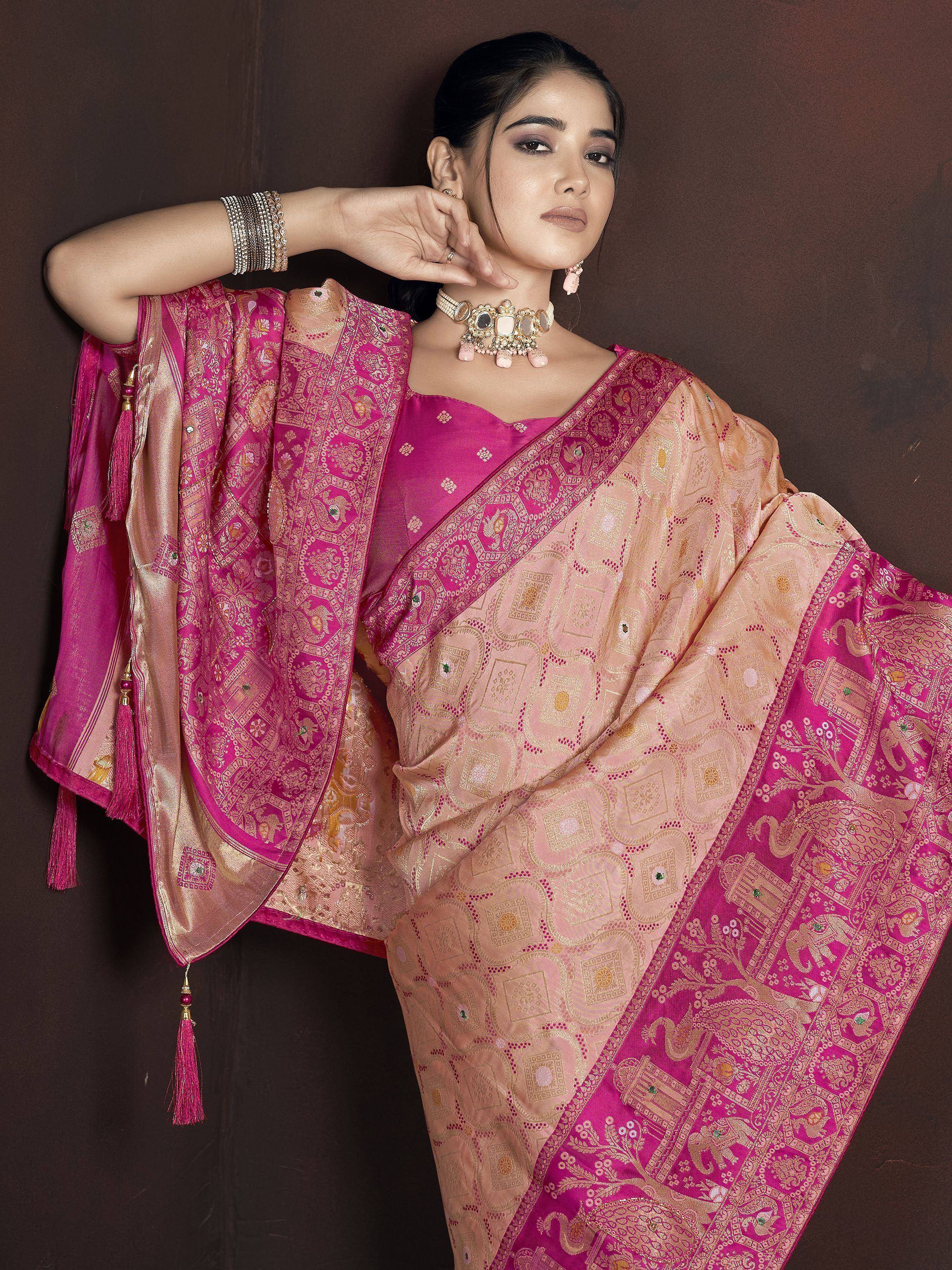 Elegant pink and gold designer saree with intricate embroidery and tassels, perfect for Indian ethnic wear.
