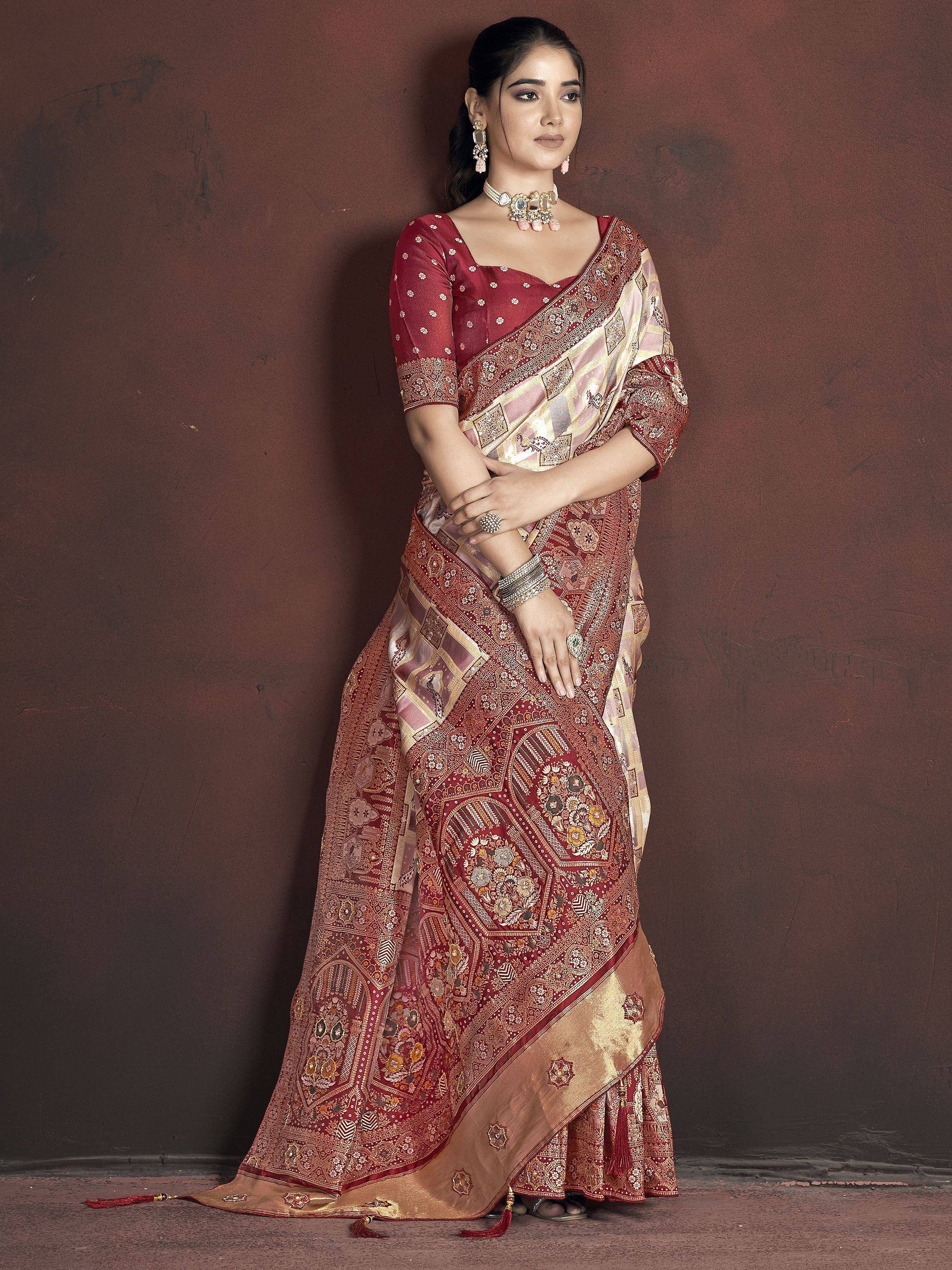 Woman in maroon and gold embroidered saree with matching blouse, traditional Indian ethnic wear