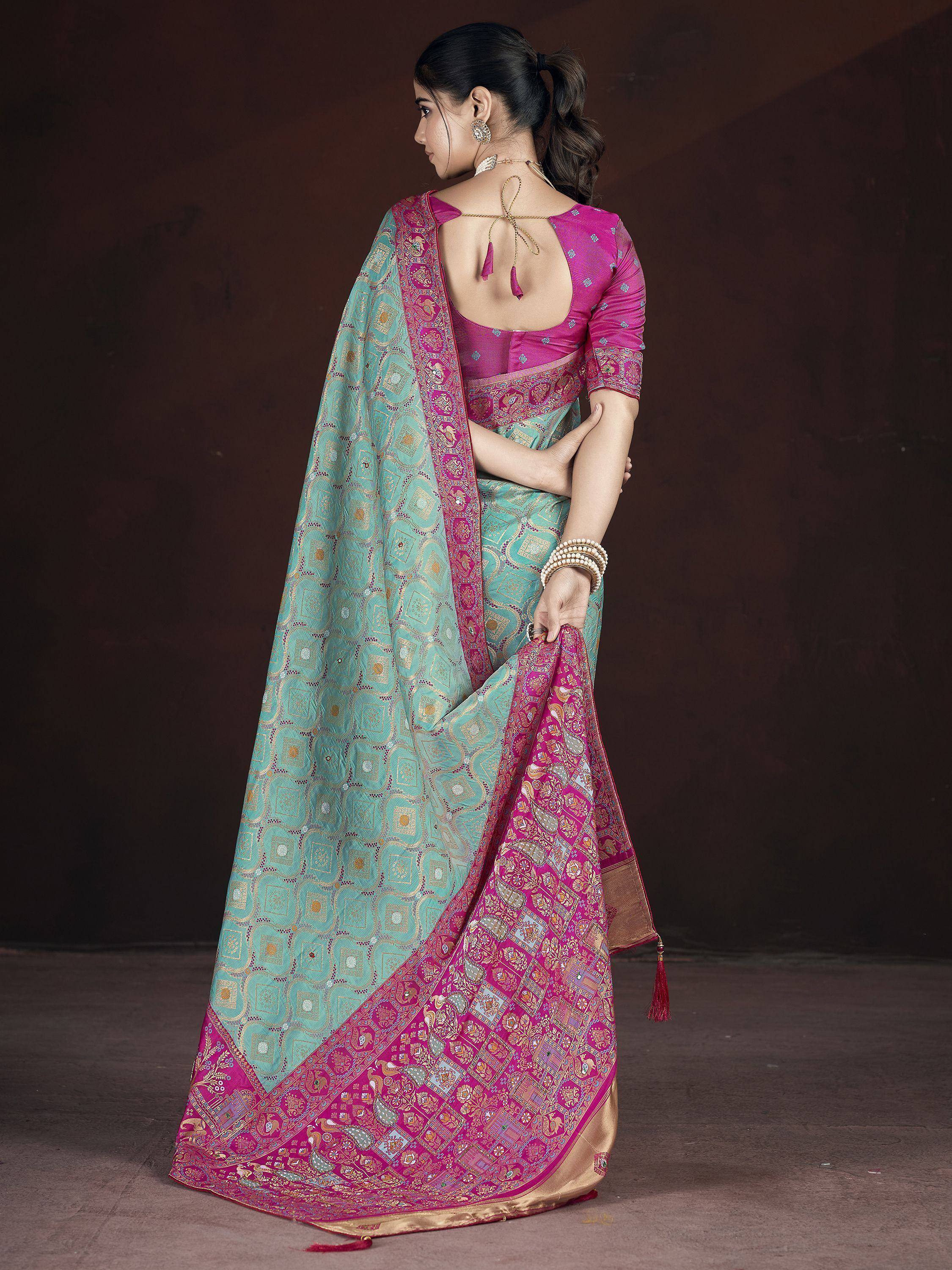Turquoise and pink designer saree with intricate embroidery and backless blouse, perfect for Indian ethnic occasions