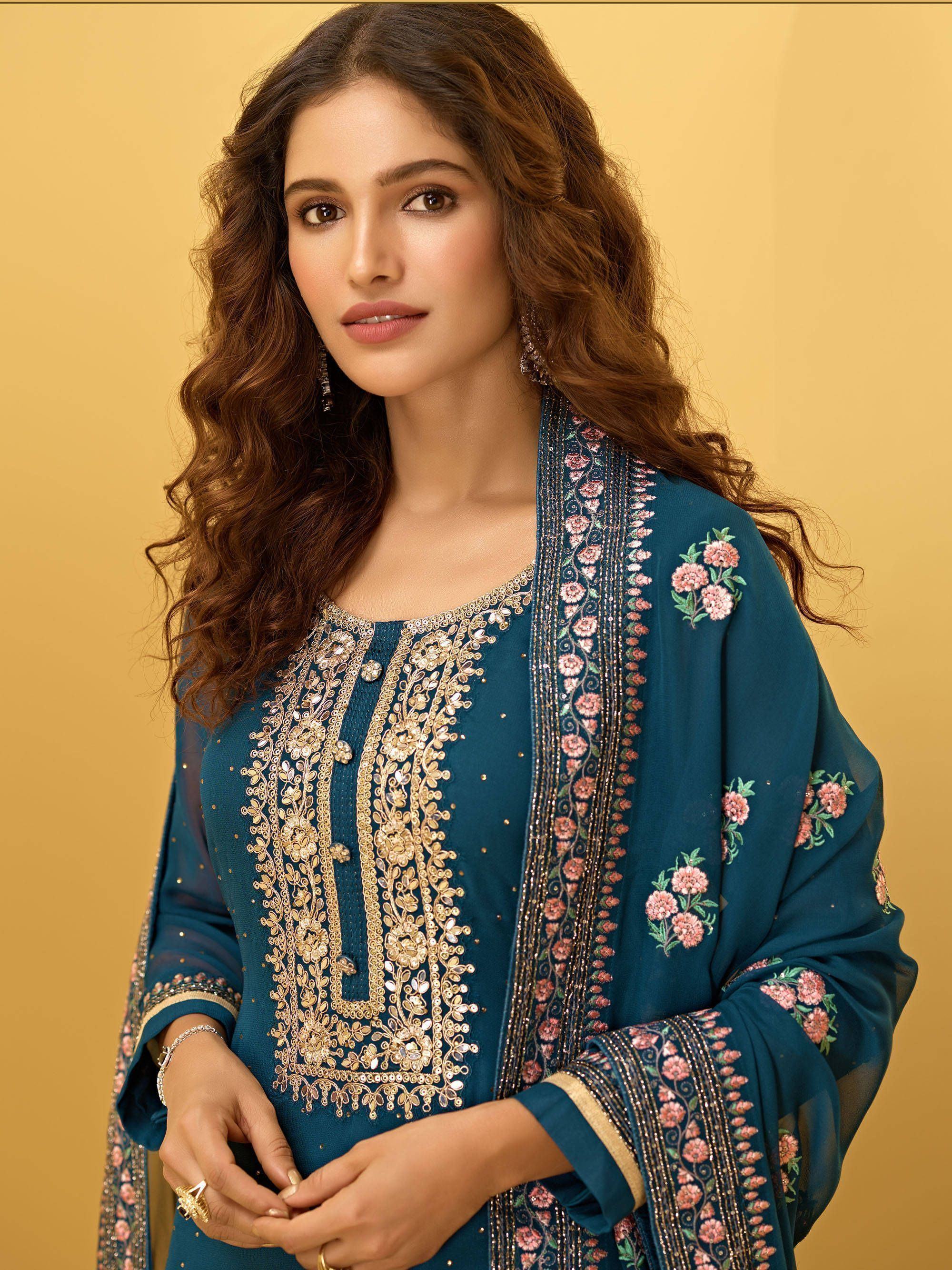 Woman in teal embroidered salwar kameez with floral dupatta, Indian ethnic wear