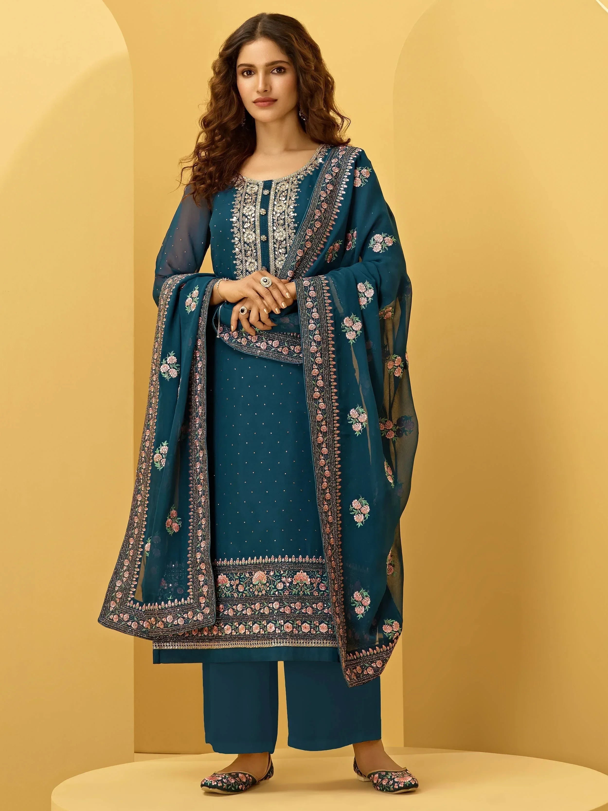 Woman wearing teal embroidered salwar kameez set with floral dupatta, Indian ethnic wear