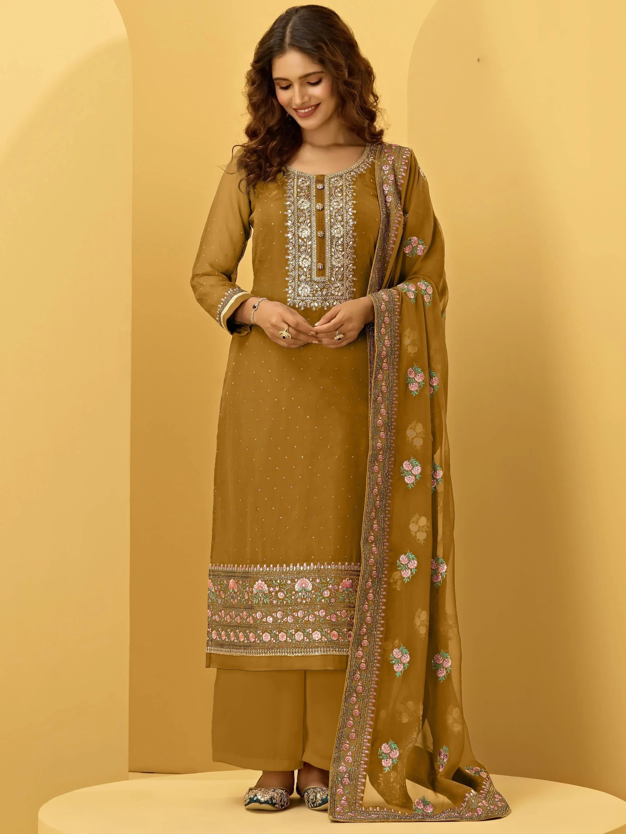Woman in mustard embroidered salwar kameez with floral dupatta, Indian ethnic wear