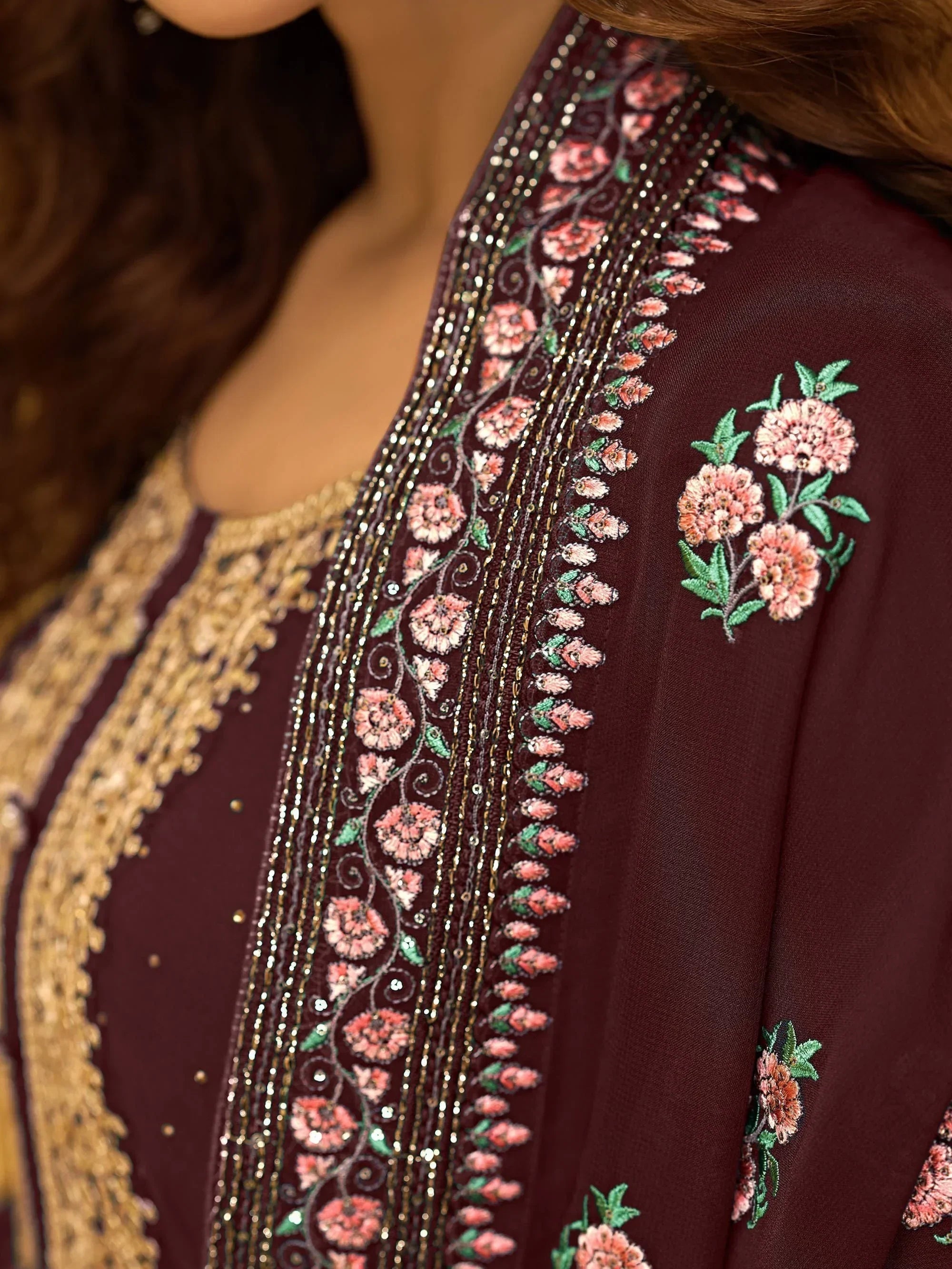 Maroon ethnic salwar kameez with intricate pink floral embroidery and gold accents