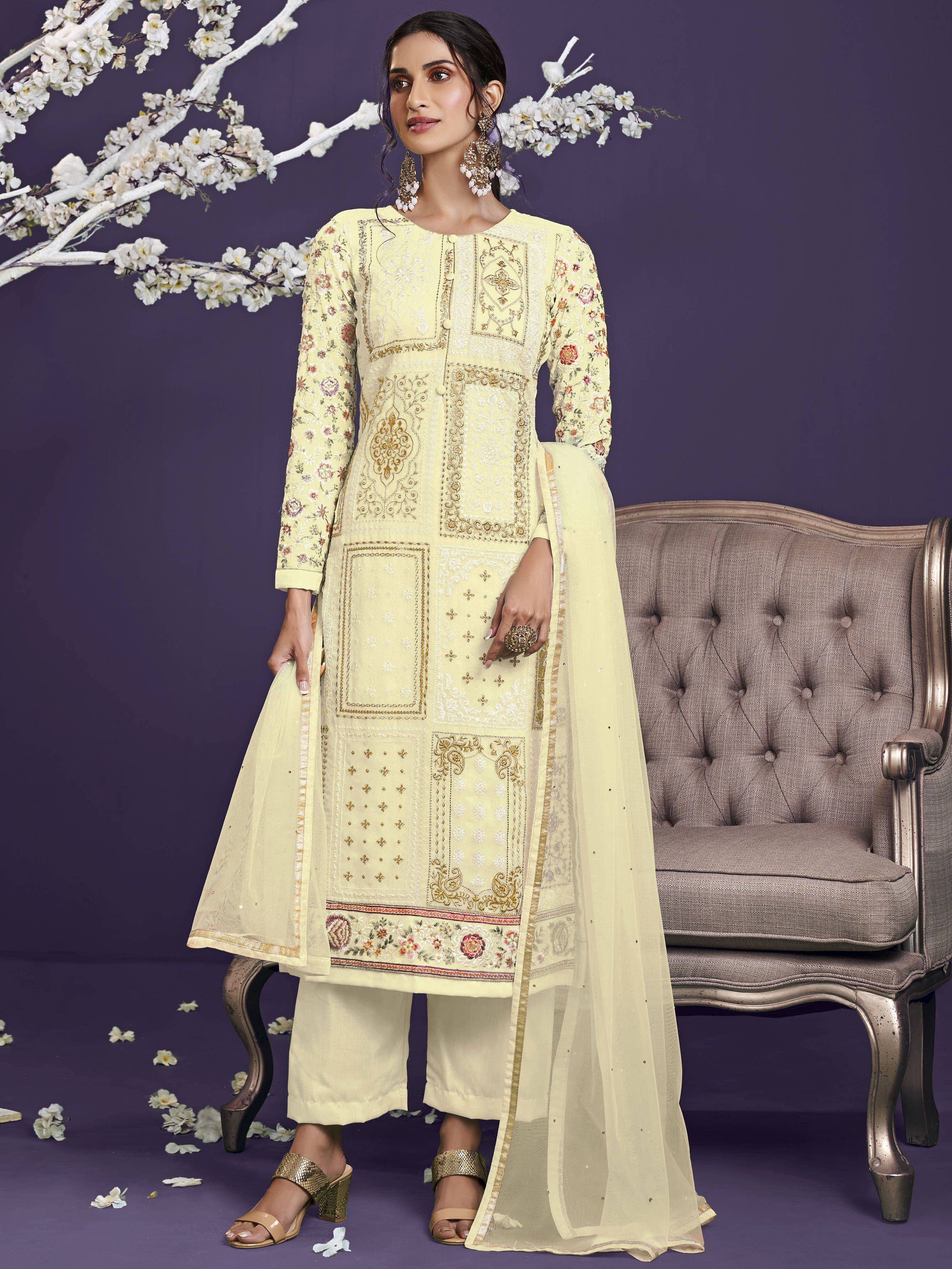 Woman wearing embroidered cream salwar kameez with dupatta, ethnic floral design