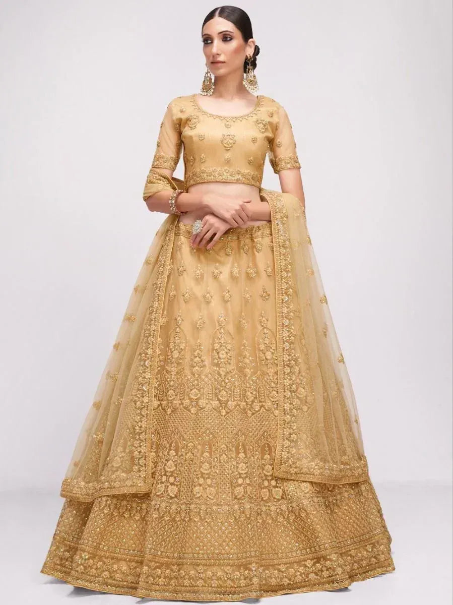 Golden embroidered lehenga choli with intricate floral detailing, perfect for Indian weddings and festive occasions.