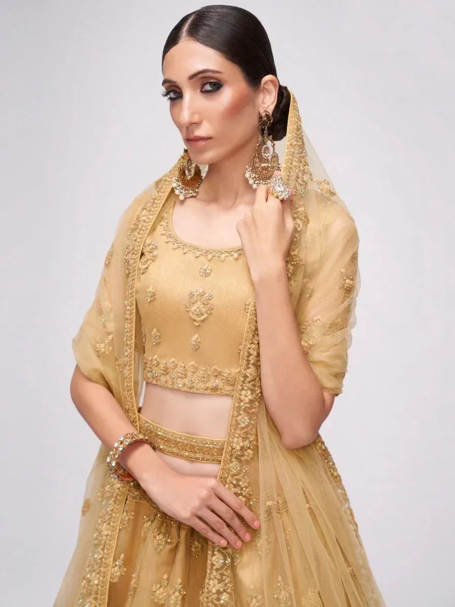 Elegant gold lehenga choli with intricate embroidery and matching dupatta, perfect for Indian weddings and festive occasions.