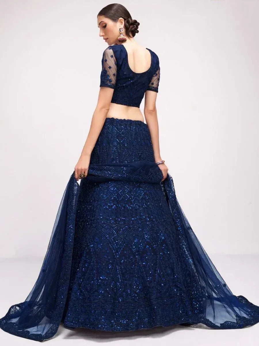 Navy blue designer lehenga choli with sequin embroidery and sheer sleeves, perfect for weddings and festive occasions.