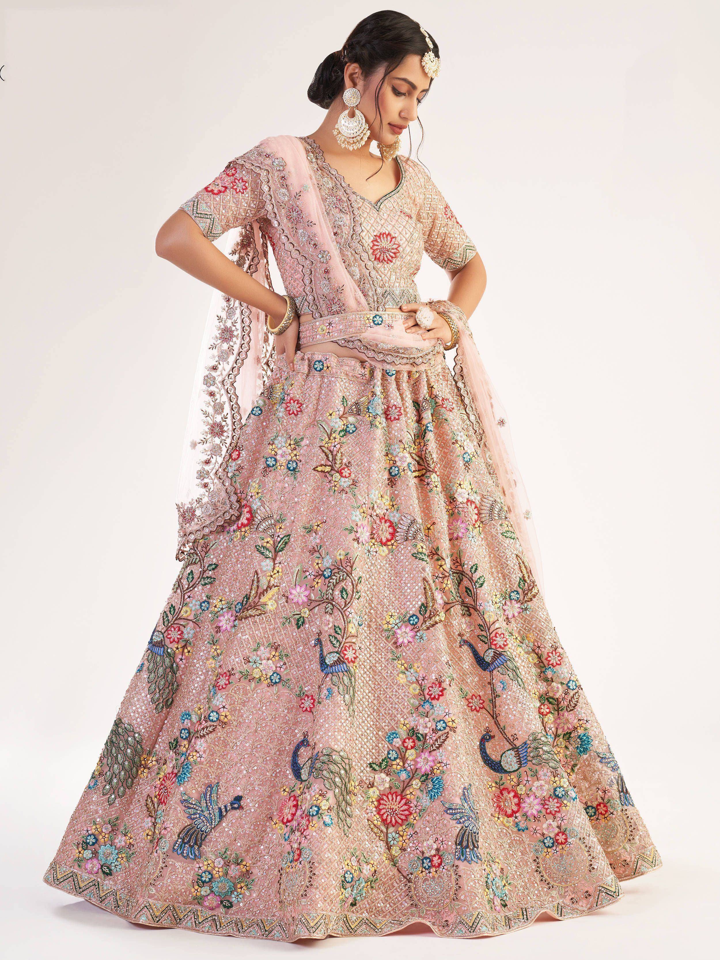 Pink floral embroidered lehenga choli with peacock motifs, perfect for Indian weddings and festive occasions.
