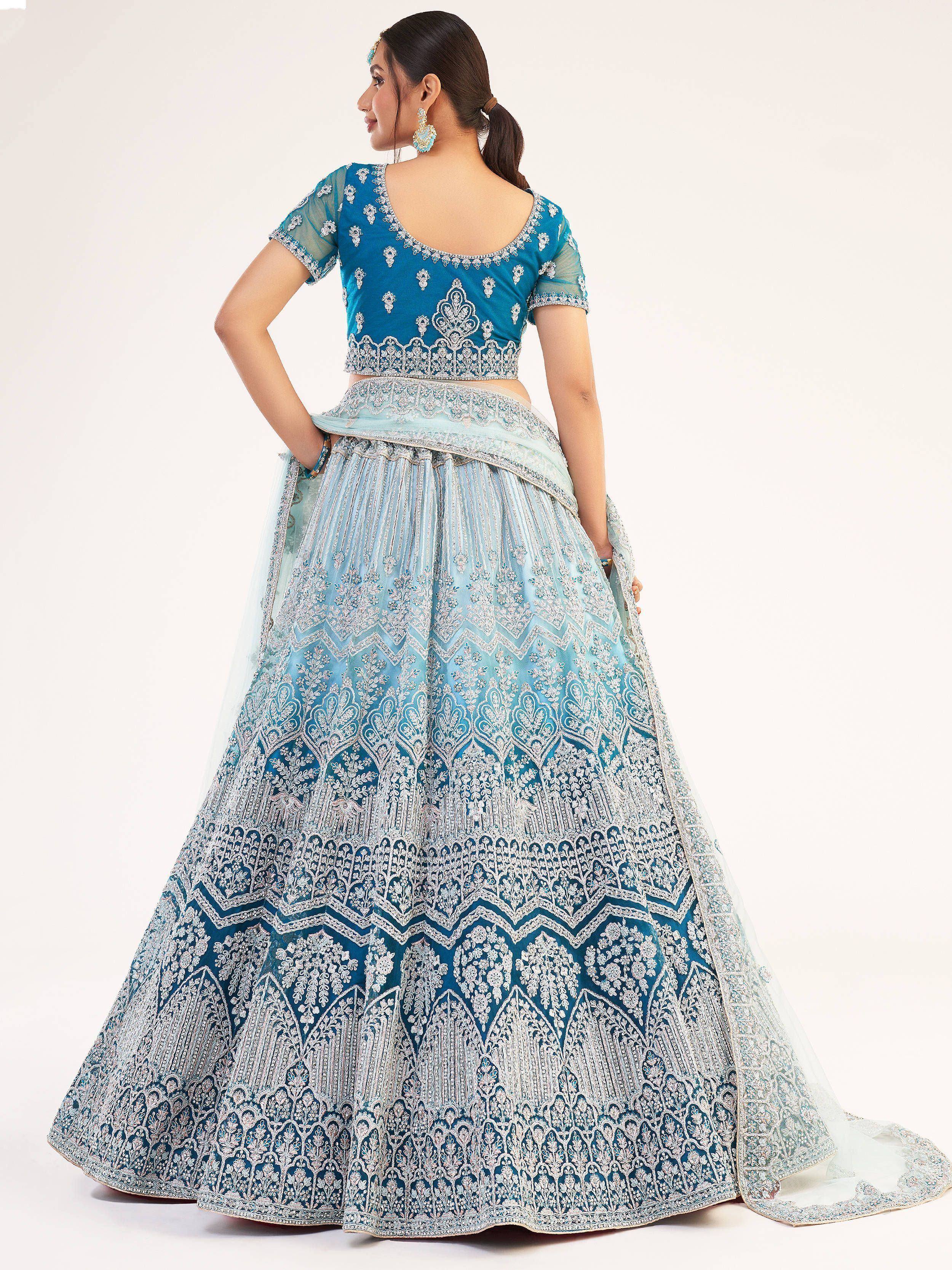 Blue embroidered lehenga choli with intricate silver work, perfect for Indian ethnic wear and weddings.