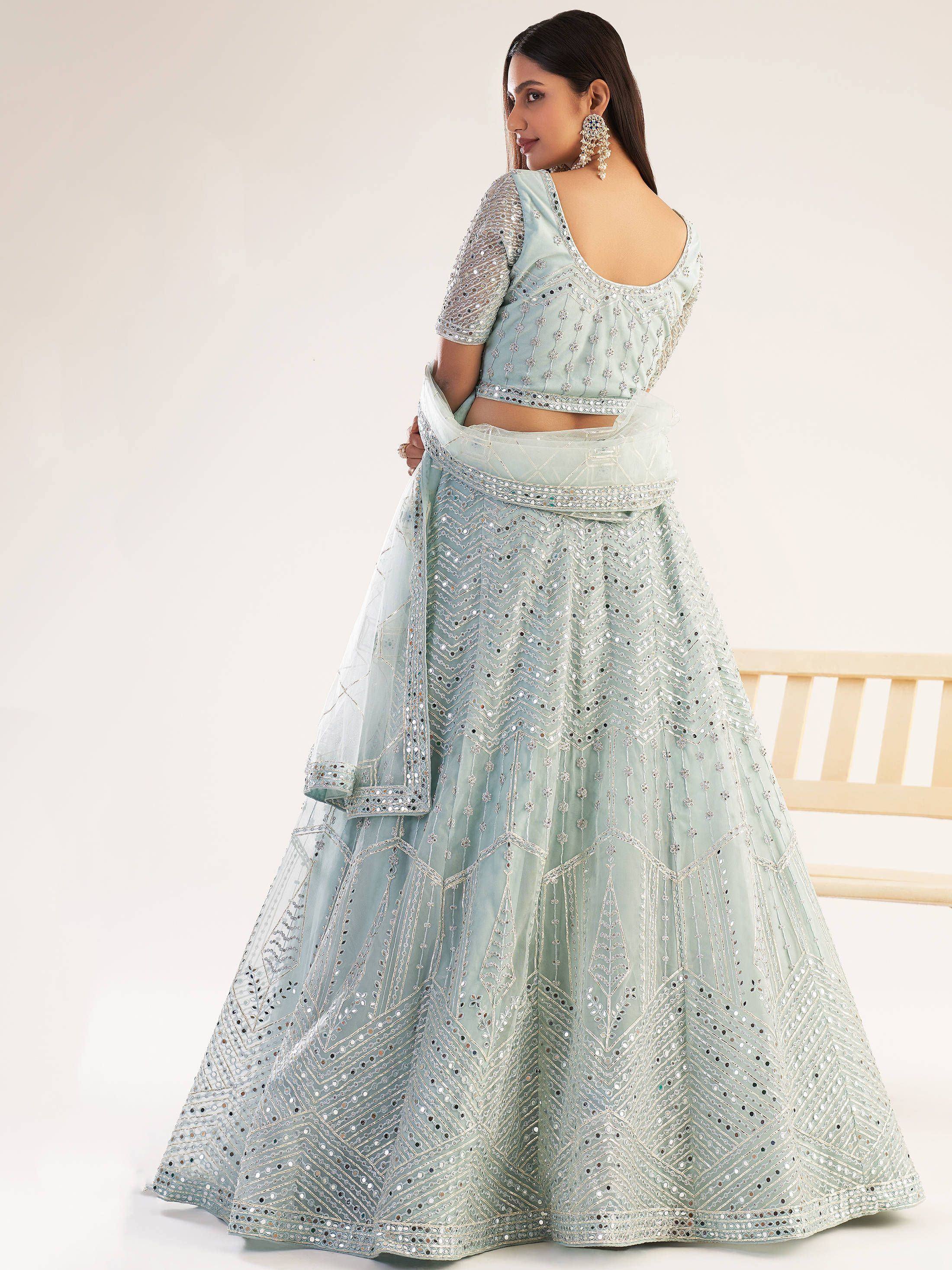 Mint green designer lehenga choli with mirror work and sheer dupatta, ethnic Indian wear