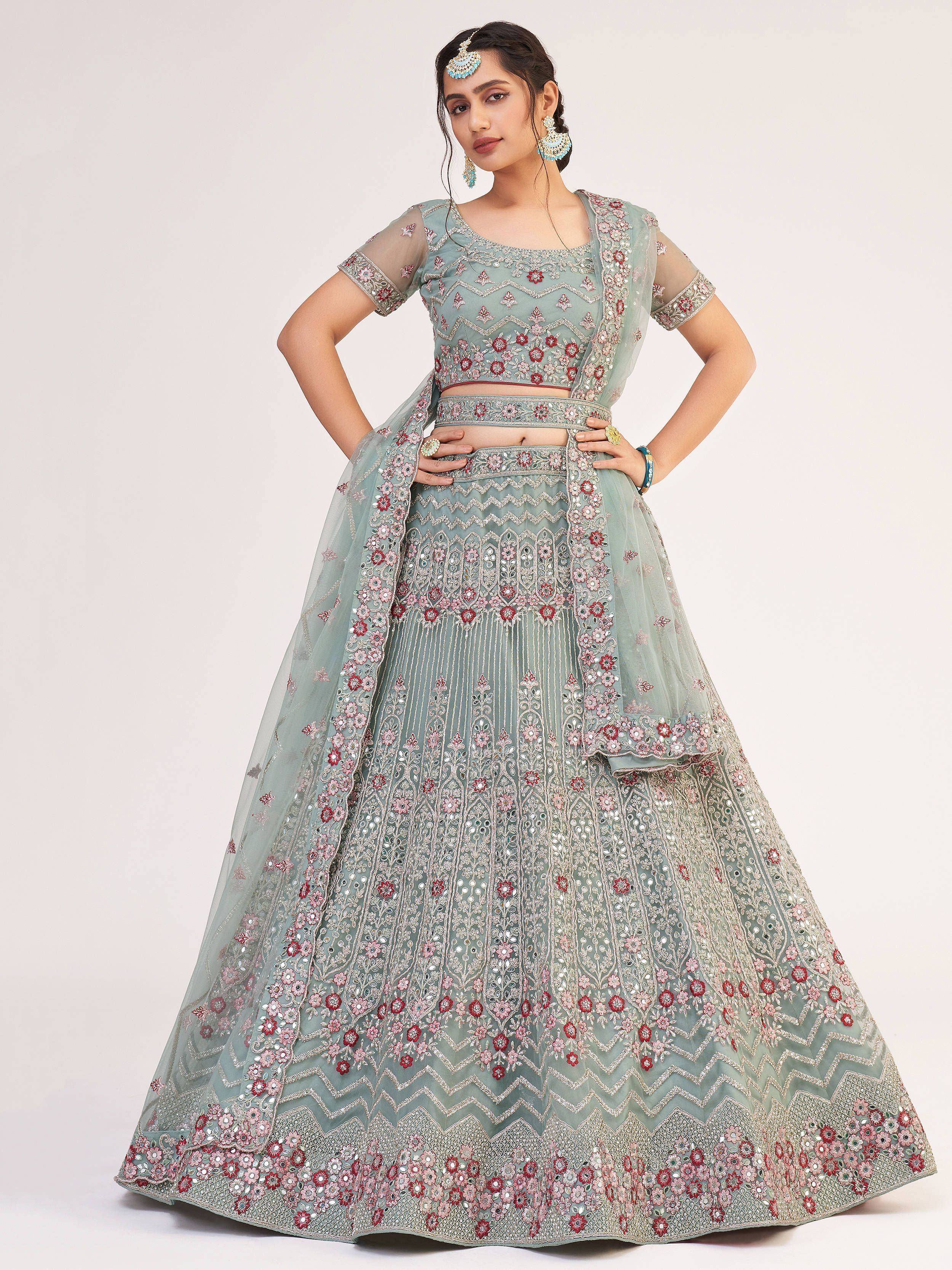 Elegant mint green lehenga choli with floral embroidery and mirror work, perfect for Indian weddings and festive occasions.