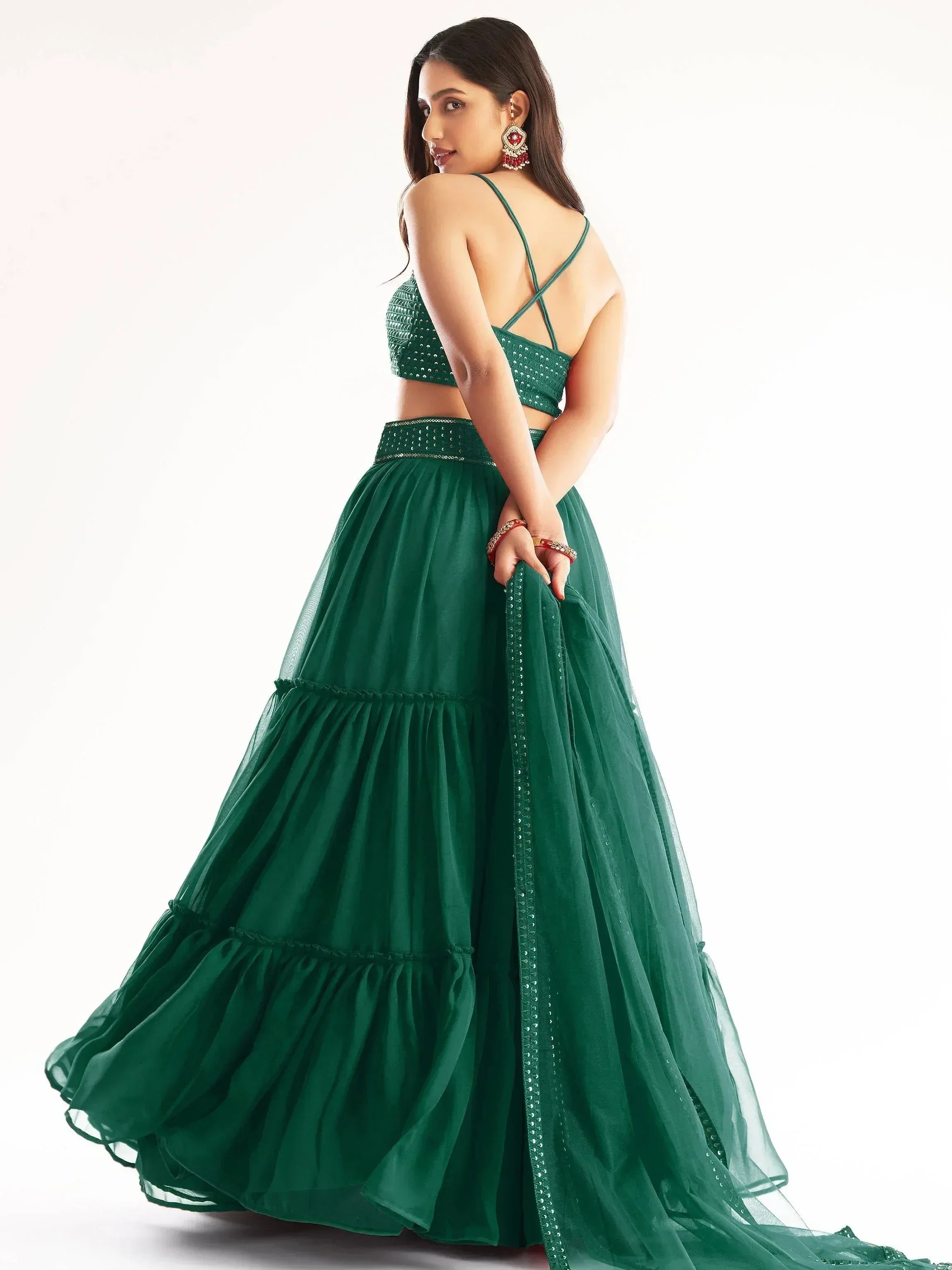 Emerald green designer lehenga choli with sequin top and layered skirt, perfect for Indian ethnic wear