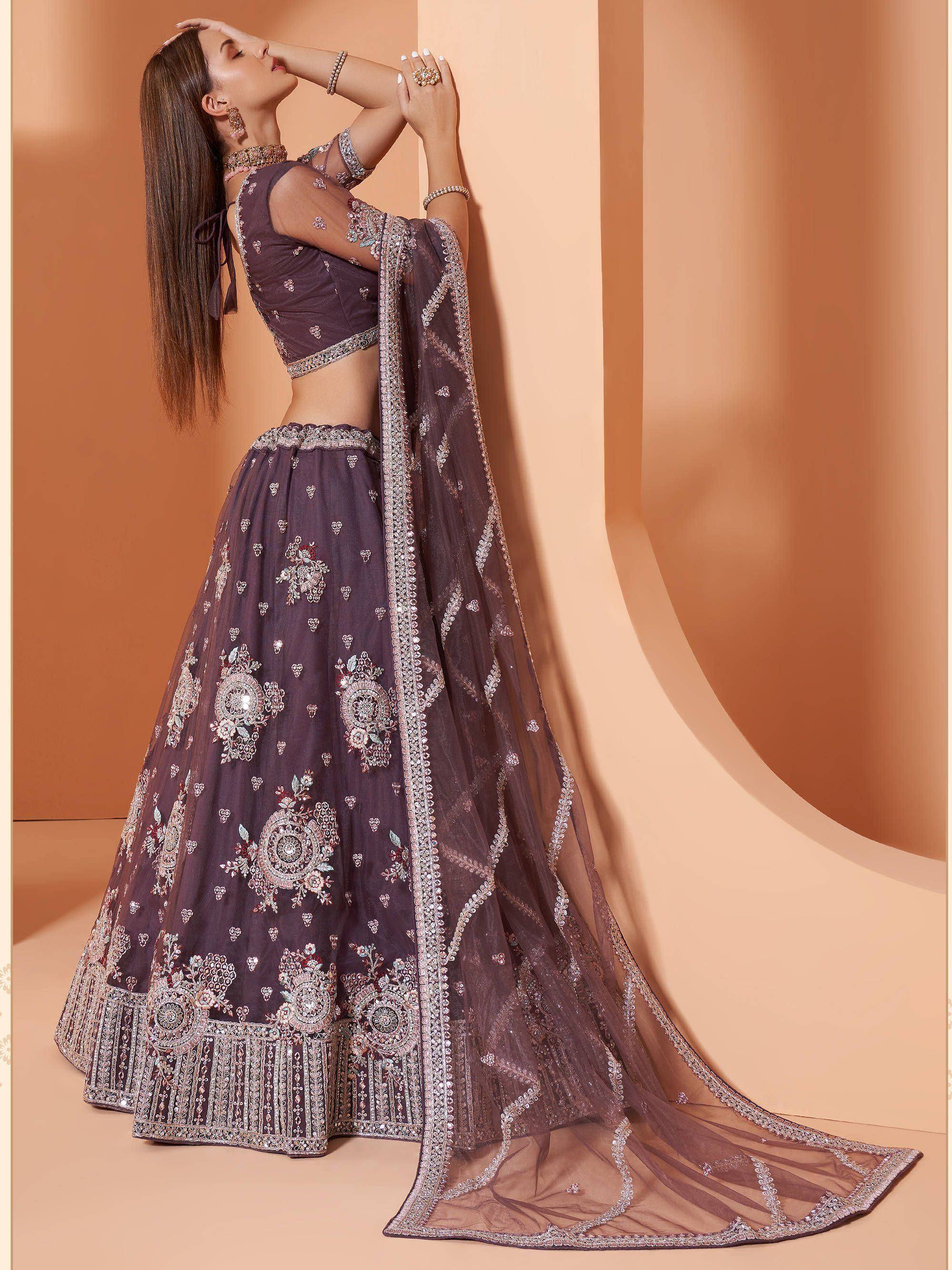 Elegant purple embroidered lehenga choli with sheer dupatta, perfect for Indian weddings and festive occasions.