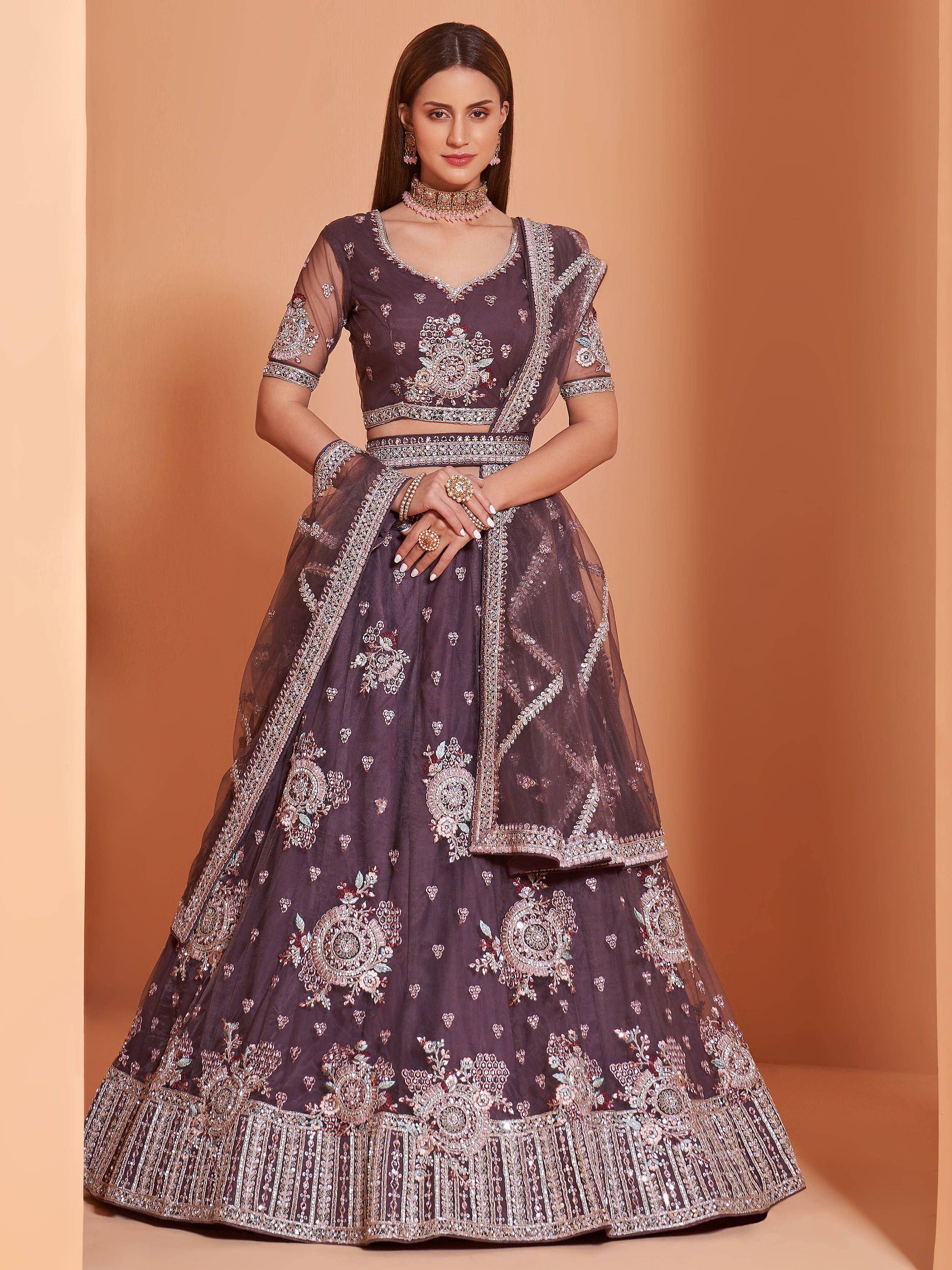 Elegant purple designer lehenga choli with heavy floral embroidery and sheer dupatta, perfect for weddings.