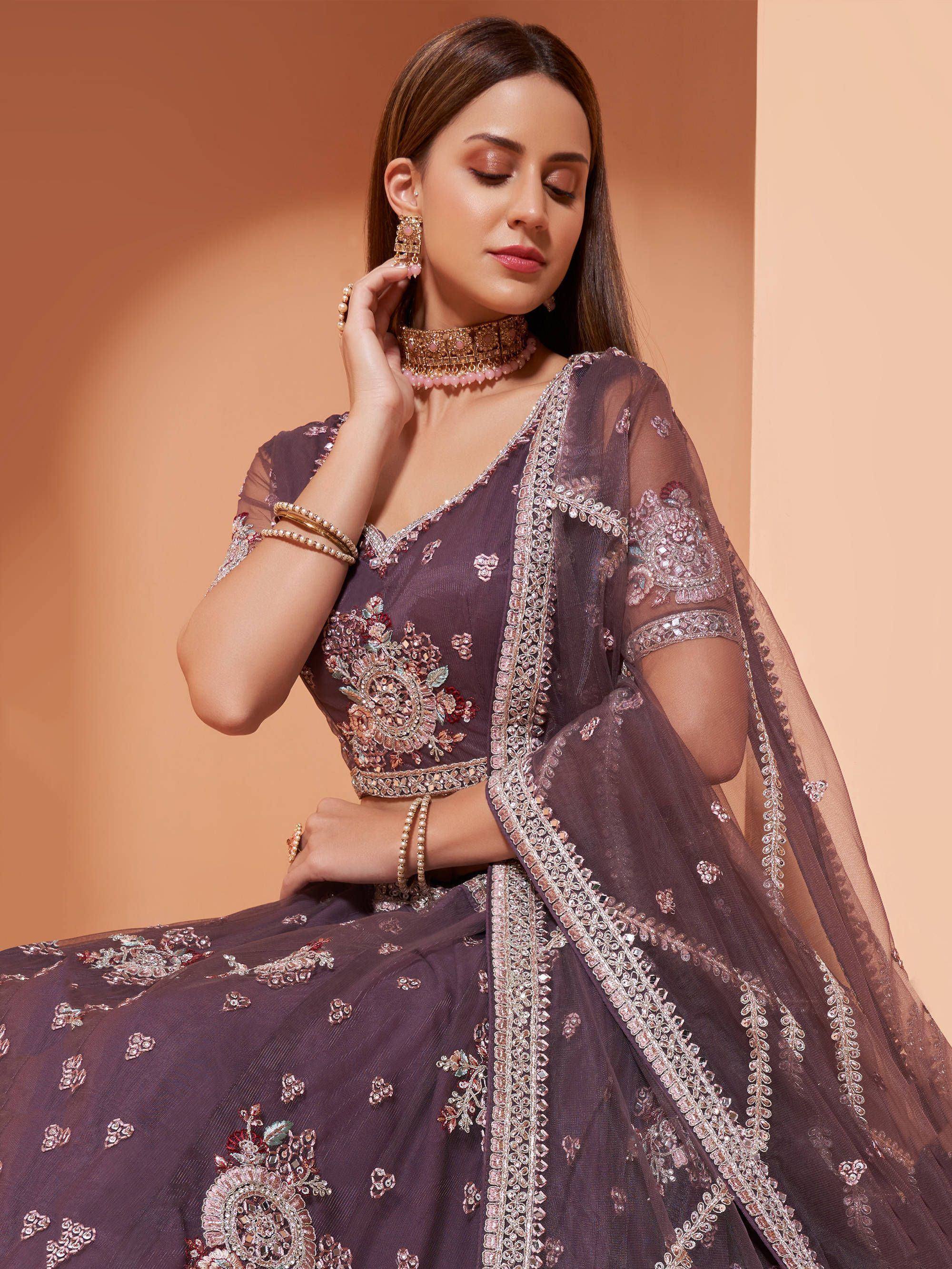 Elegant purple designer lehenga choli with floral embroidery and sheer dupatta, perfect for Indian weddings.