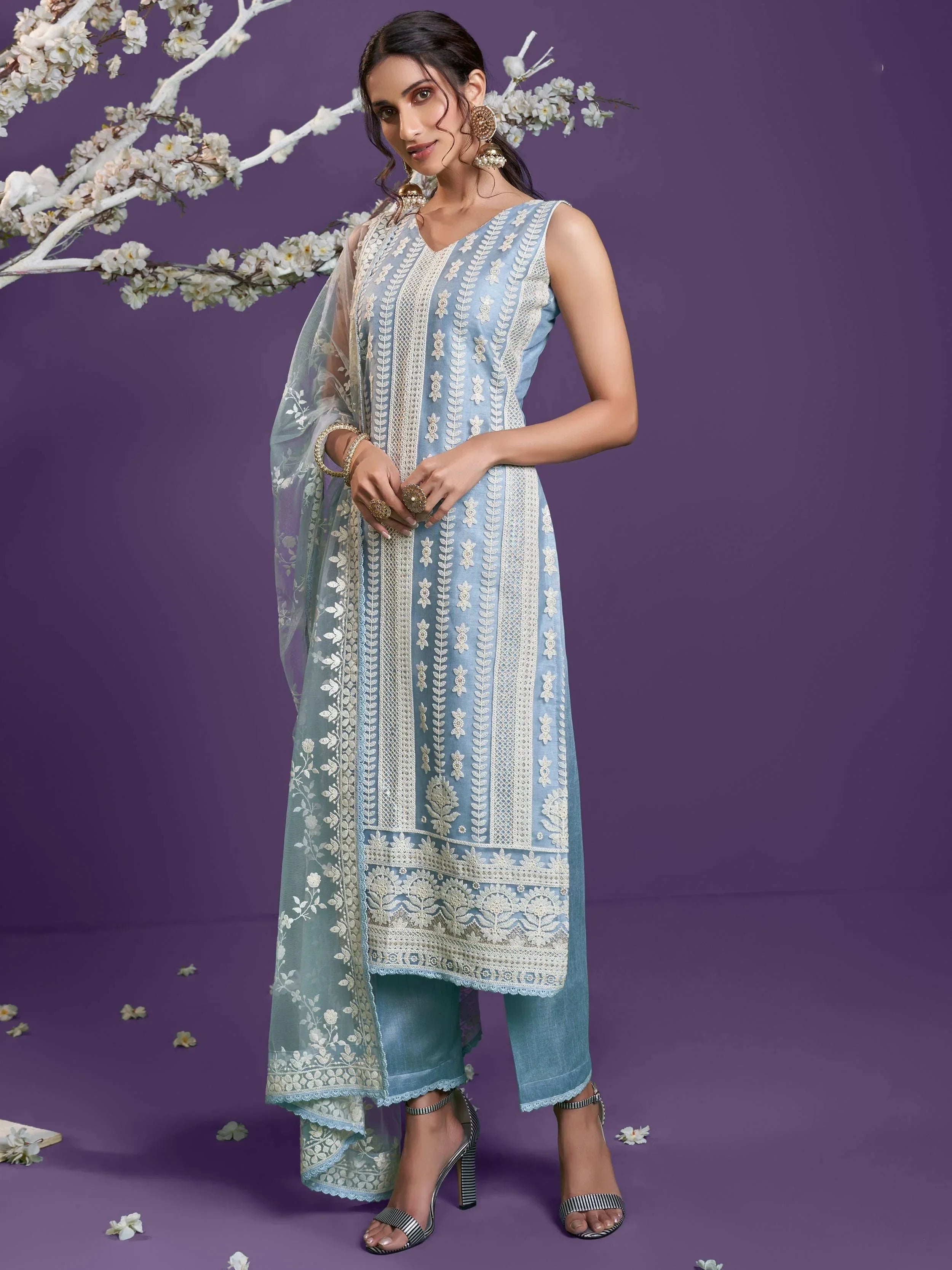 Woman in blue embroidered salwar kameez with dupatta, ethnic Indian wear, floral accents