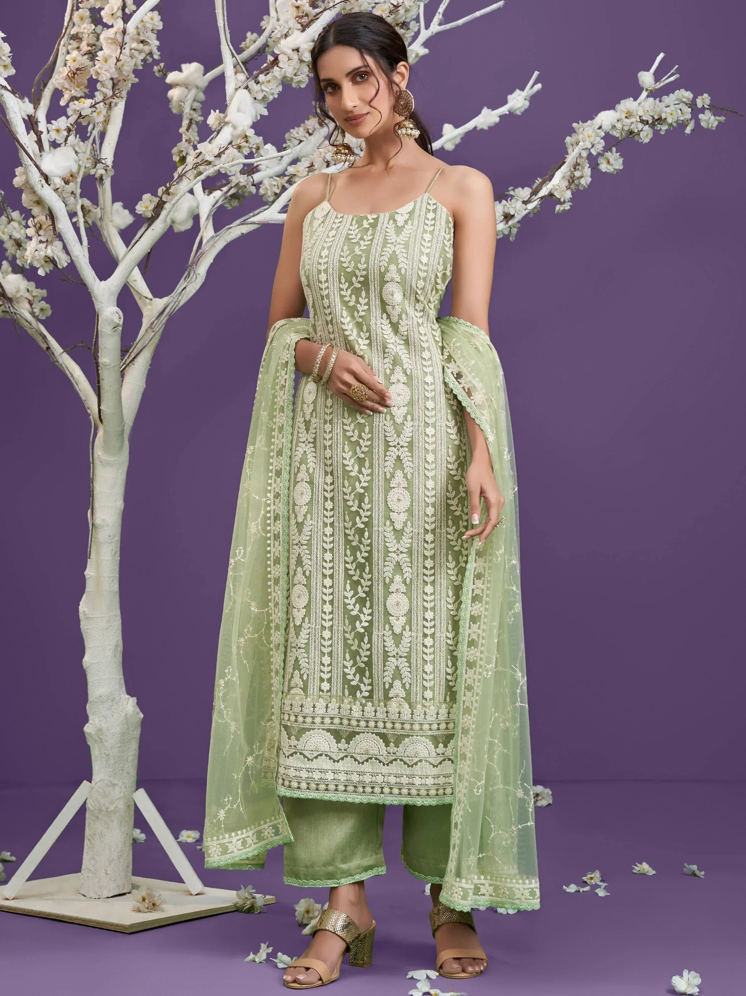 Woman in pastel green Lucknowi salwar kameez with dupatta, floral embroidery, festive wear