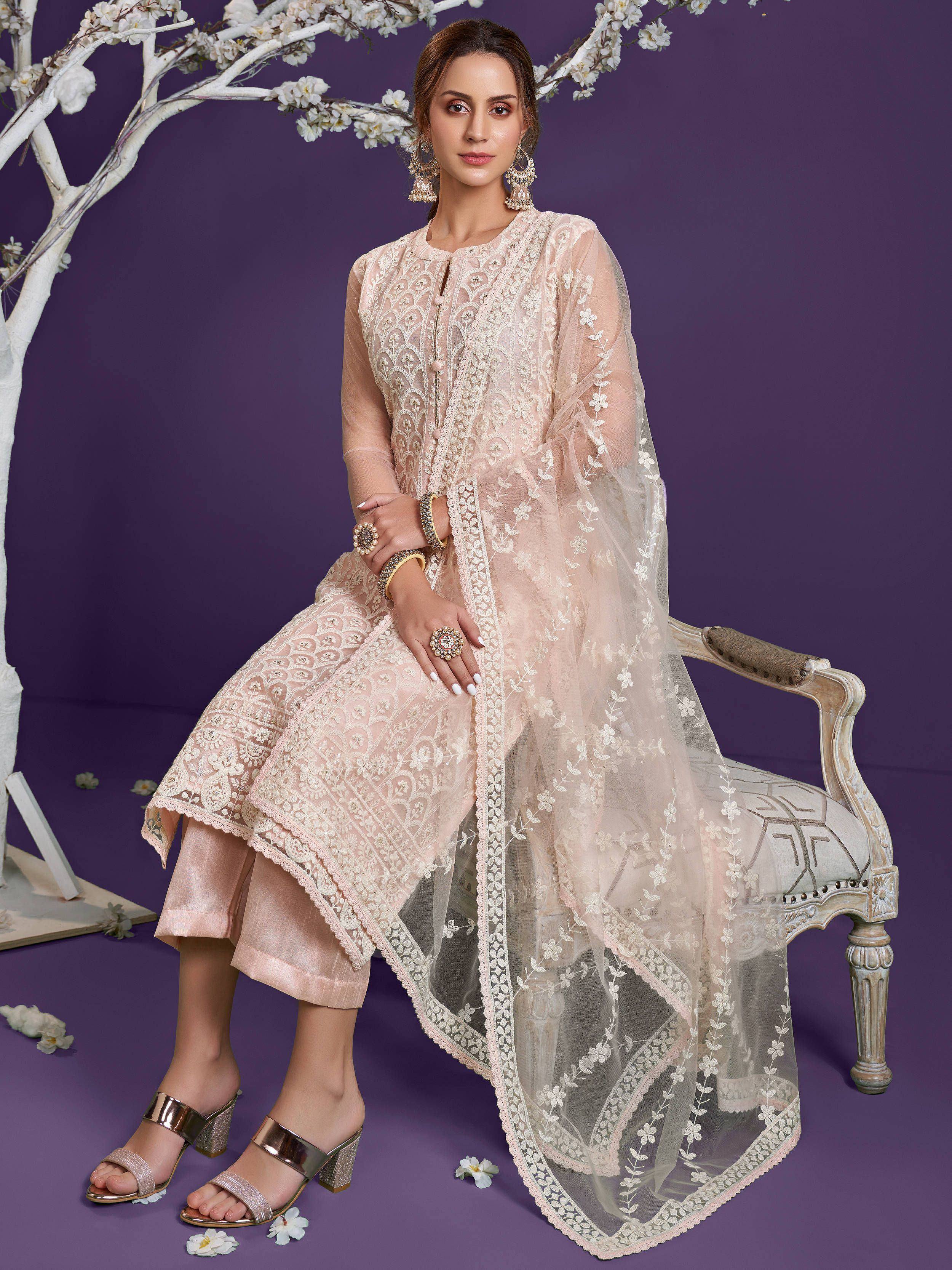 Elegant blush pink embroidered kurta with sheer dupatta, styled for festive occasions, paired with metallic heels.