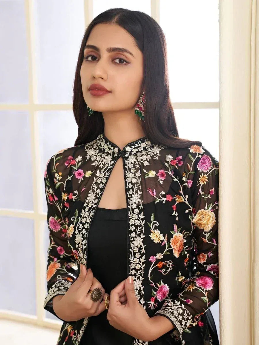 Black floral embroidered ethnic jacket with sheer sleeves, paired with black top, perfect for Indian occasions.