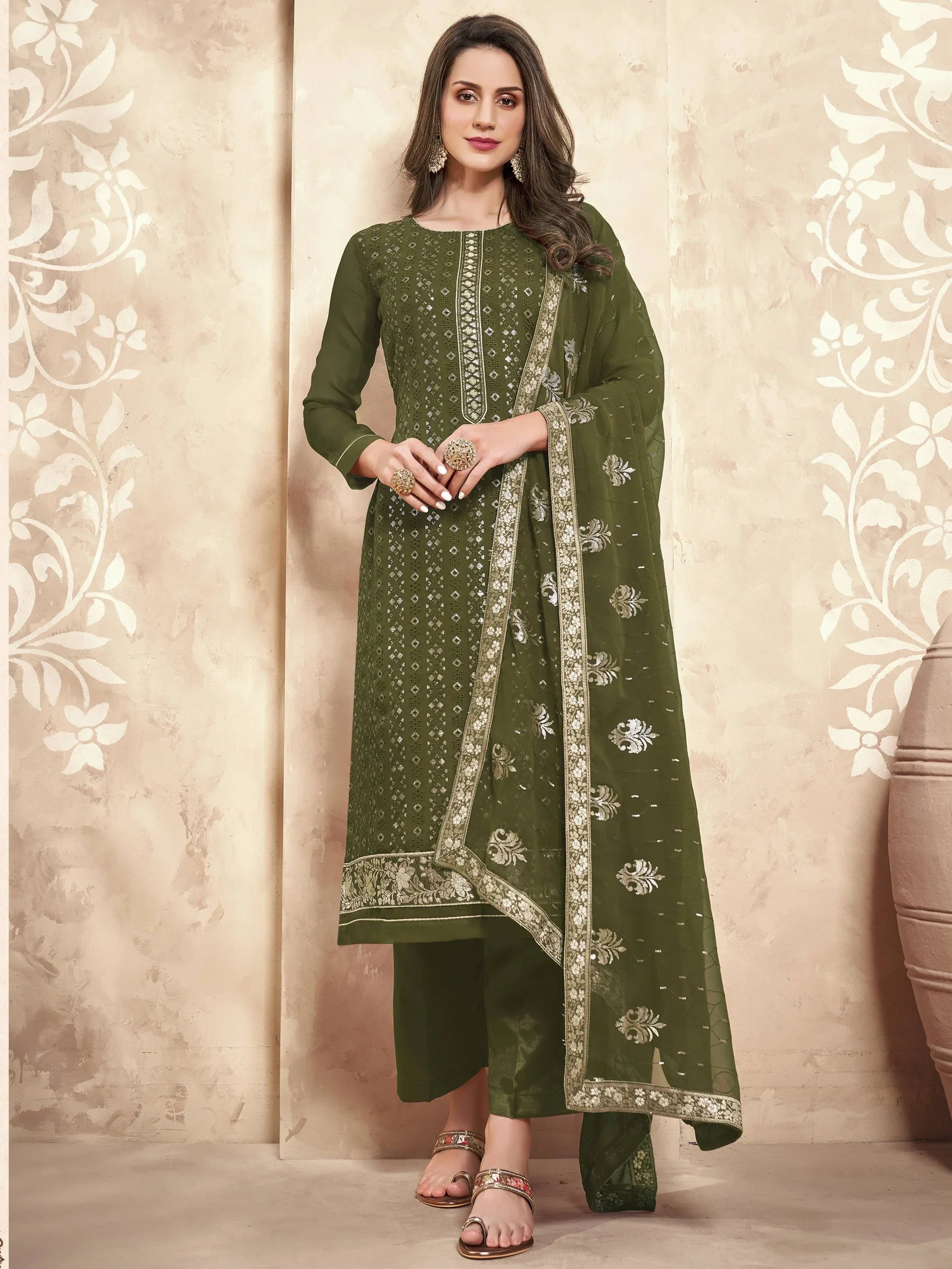 Woman wearing olive green embroidered salwar kameez with matching dupatta