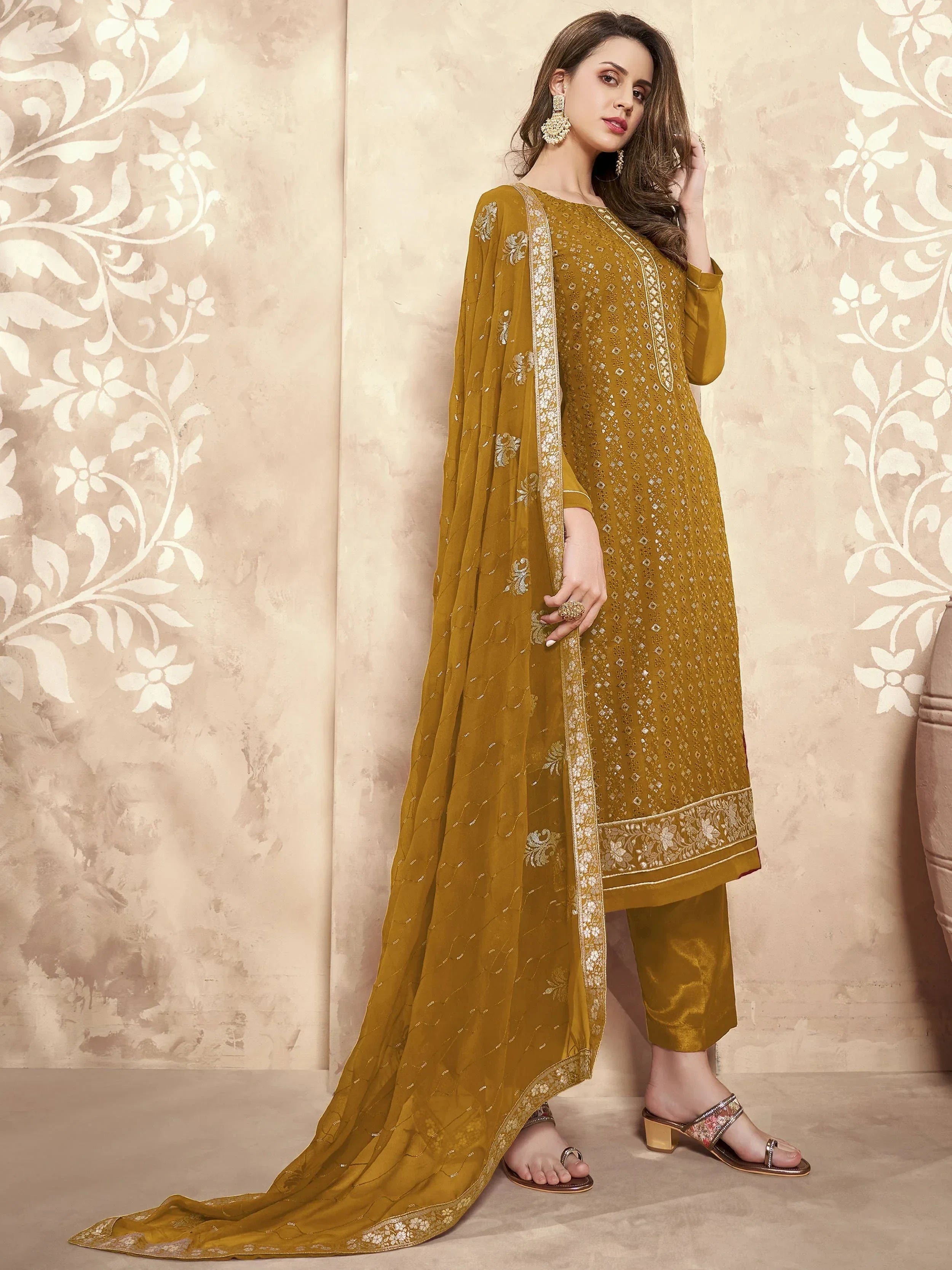 Woman wearing mustard embroidered straight cut salwar kameez with matching dupatta