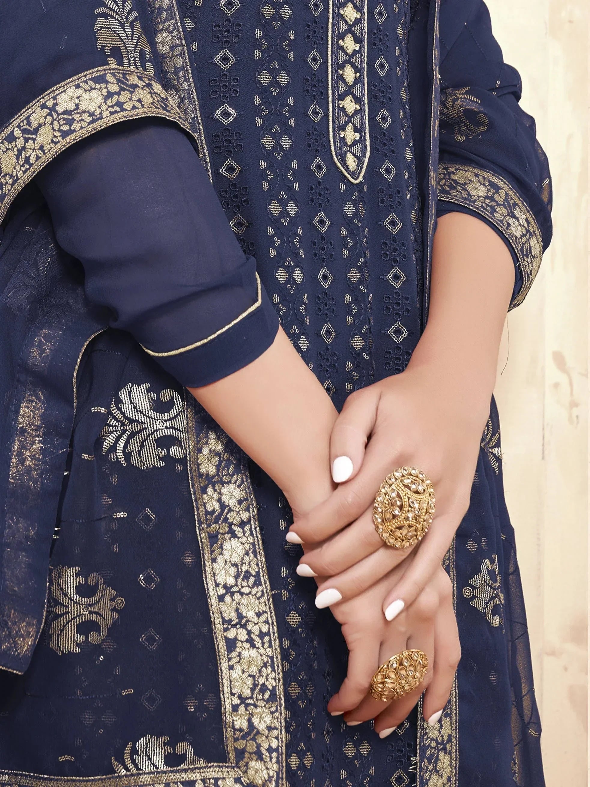 Navy blue embroidered salwar kameez with gold detailing and statement gold rings