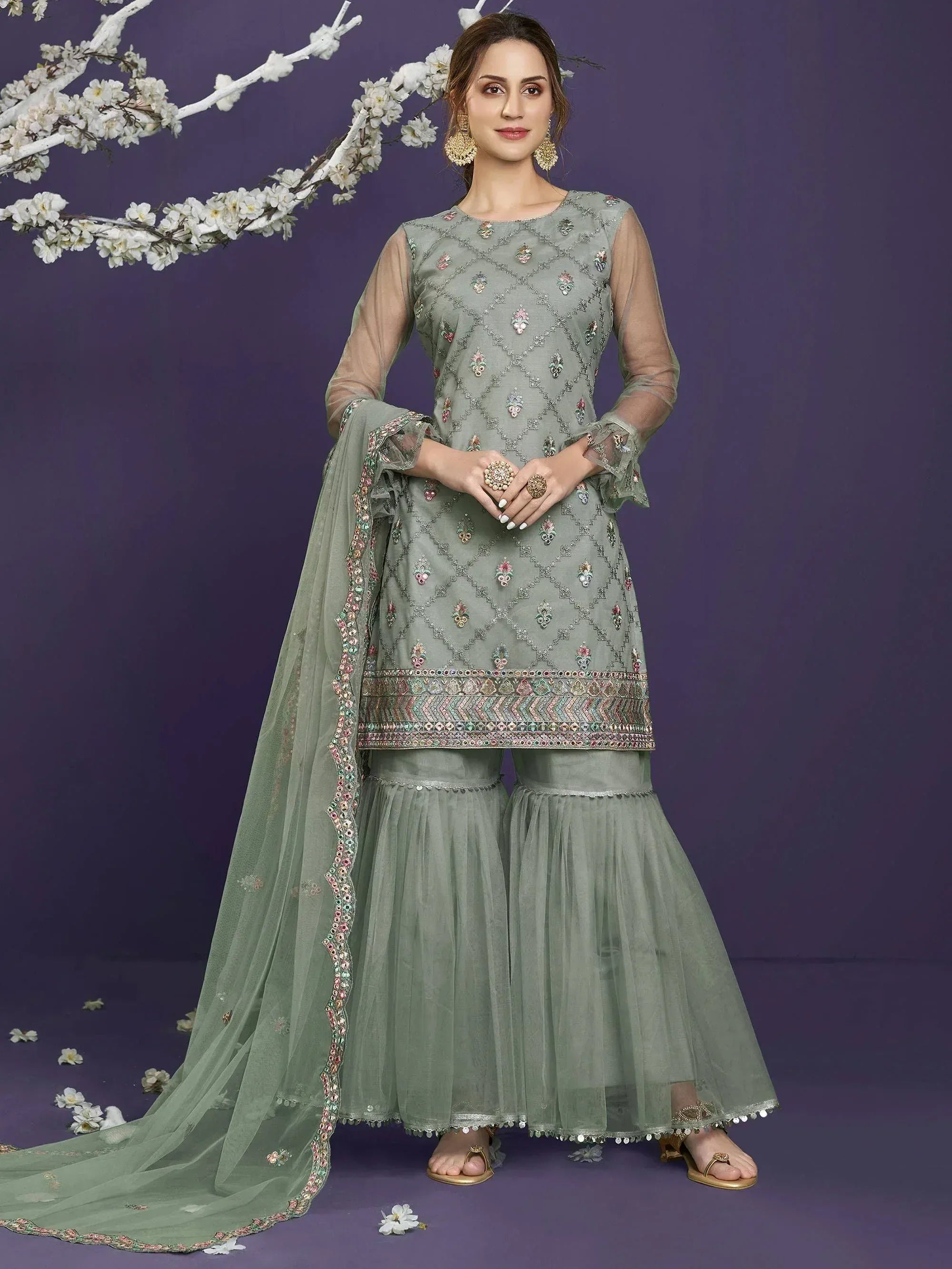 Elegant sage green embroidered salwar kameez with flared pants and dupatta, perfect for Indian ethnic wear occasions.