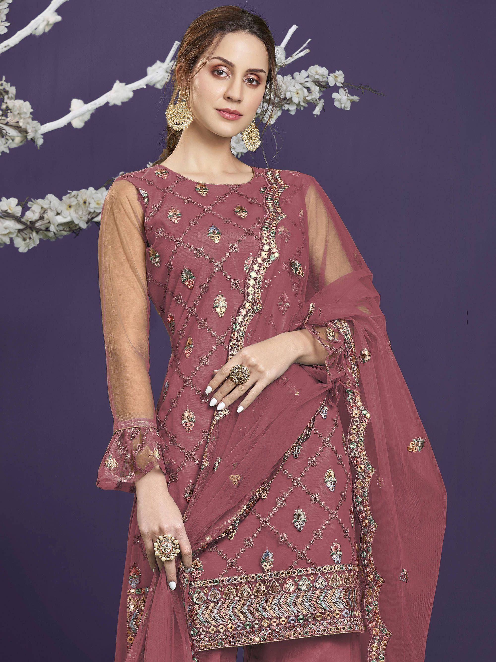 Elegant maroon ethnic gown with intricate embroidery and mirror work, perfect for Indian celebrations.