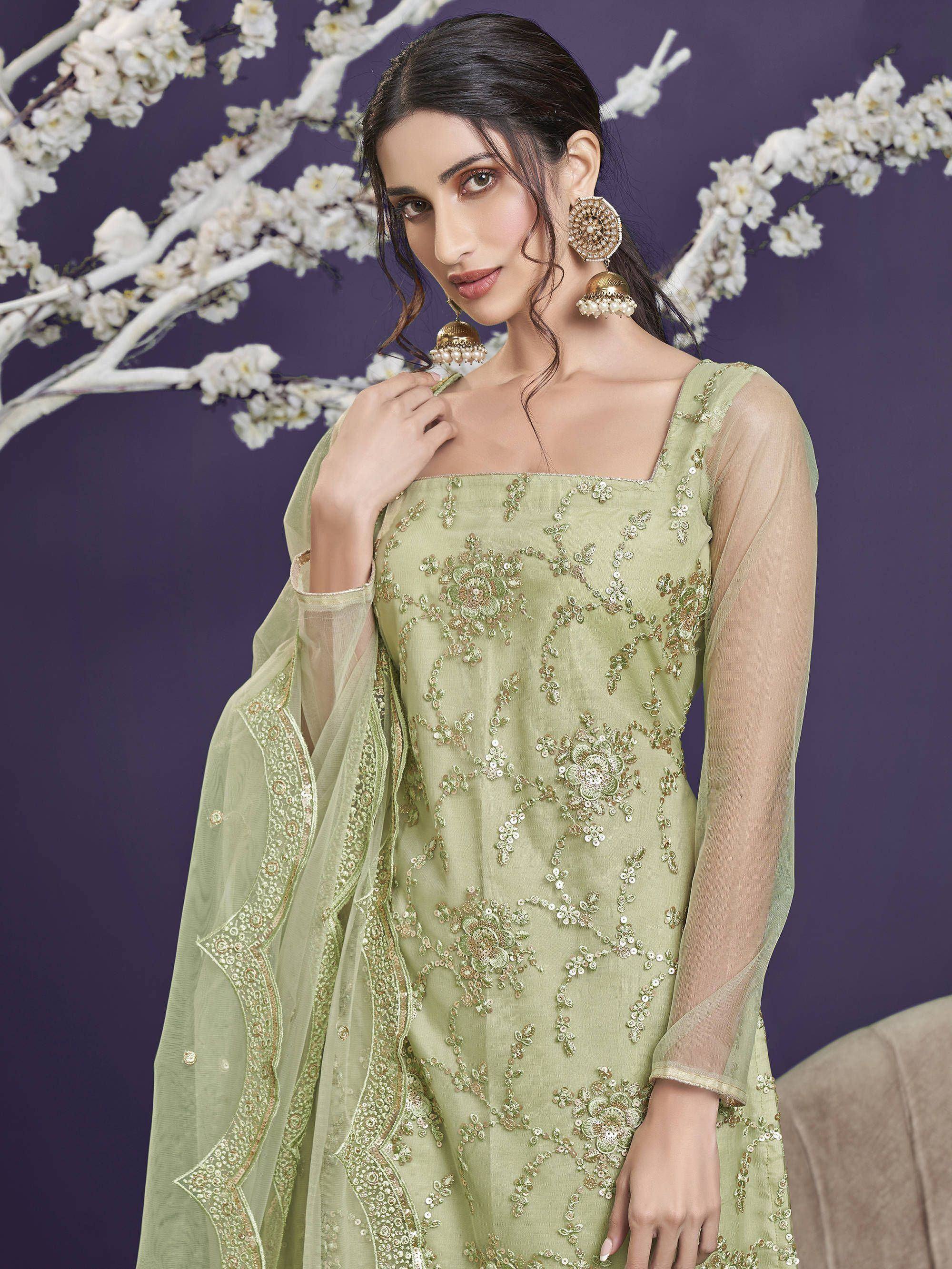 Light green embroidered ethnic gown with sheer sleeves and floral detailing, perfect for Indian occasions.
