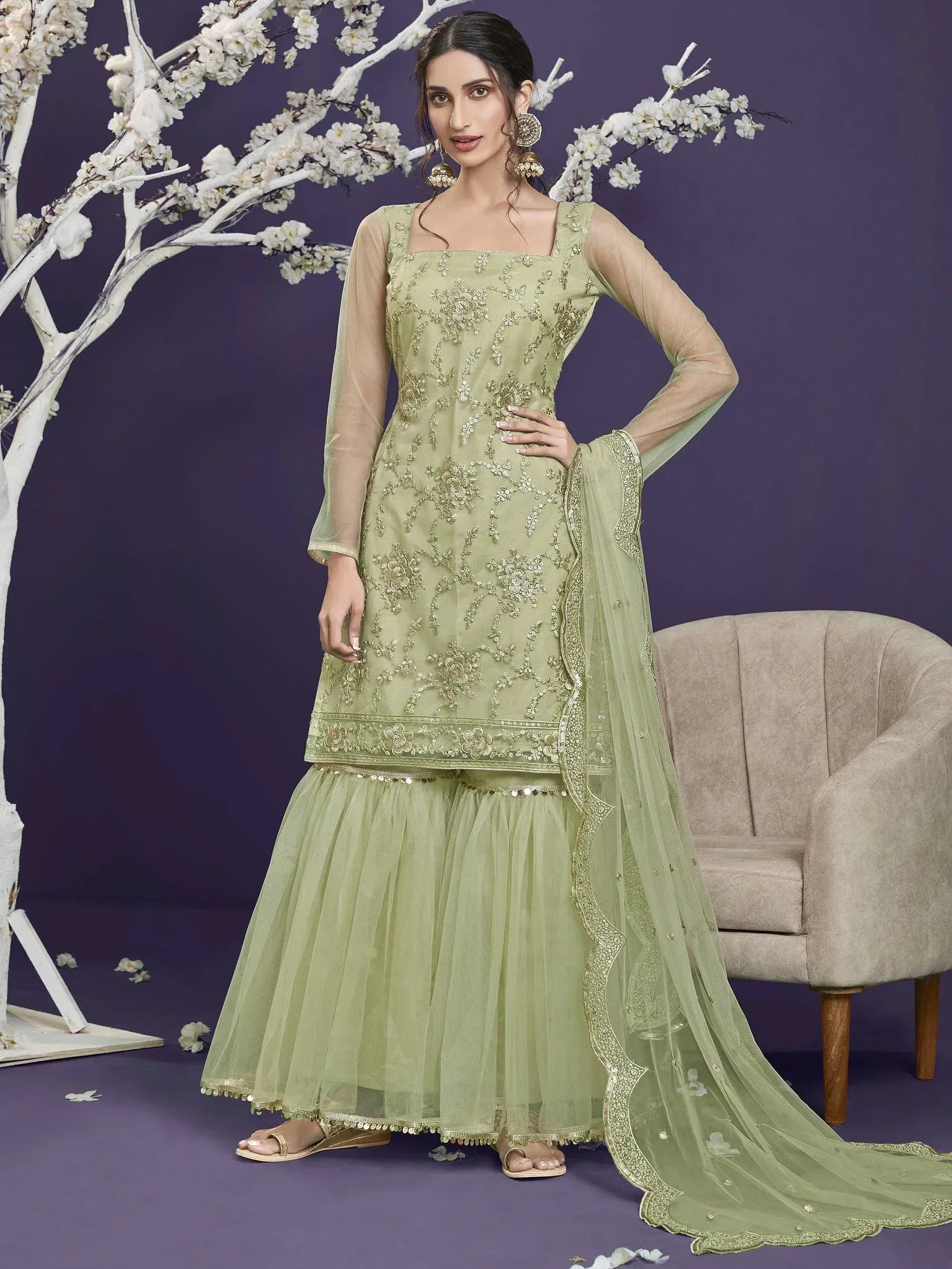 Elegant light green embroidered salwar kameez with tulle skirt and dupatta, perfect for festive occasions.
