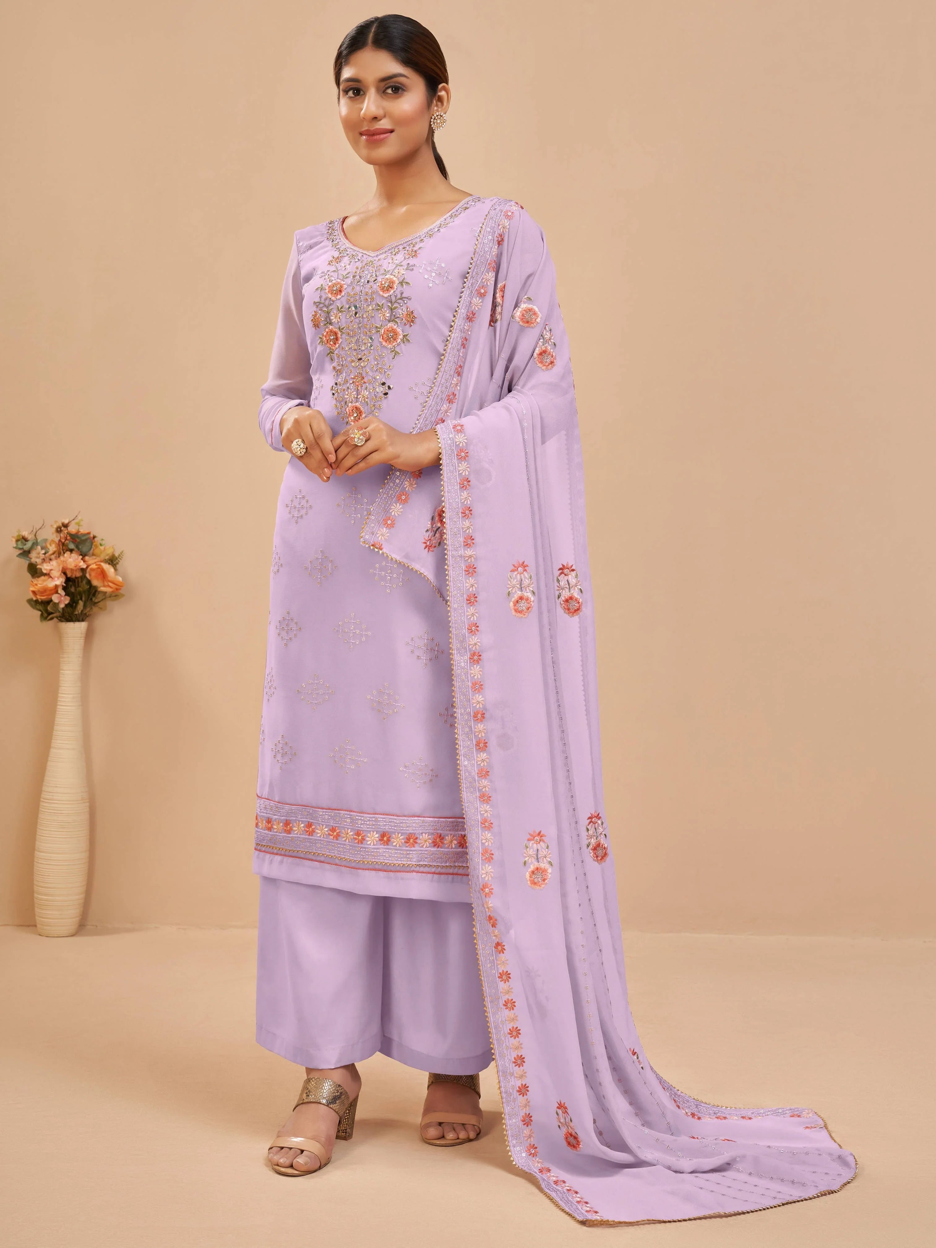 Woman wearing lavender embroidered salwar kameez with matching dupatta, ethnic wear