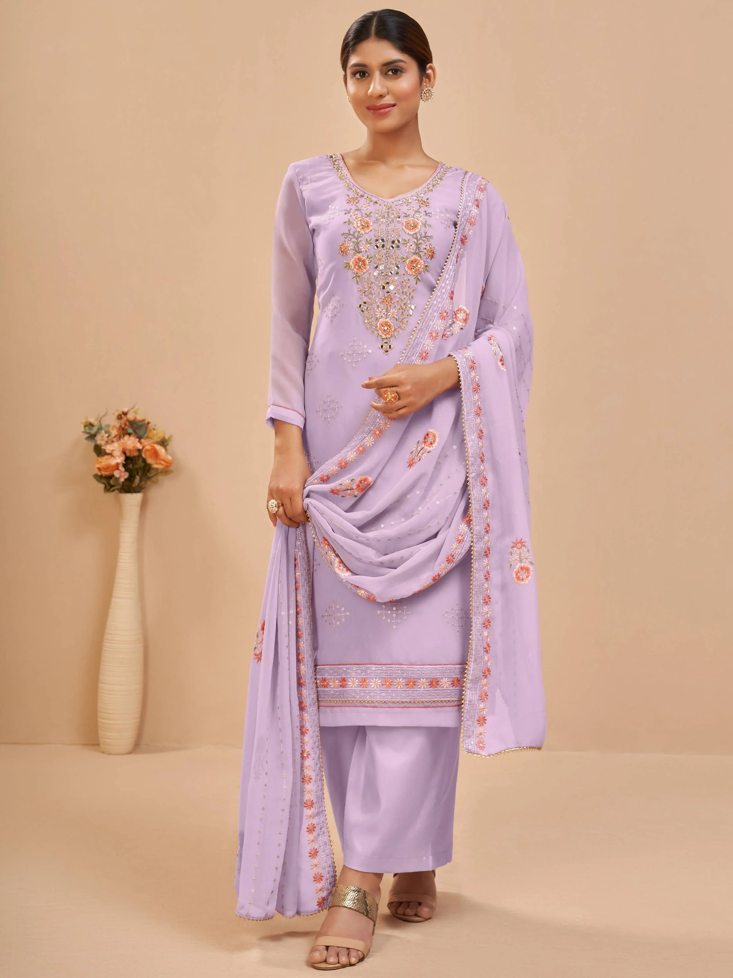 Woman wearing lavender embroidered salwar kameez with dupatta, ethnic Indian outfit