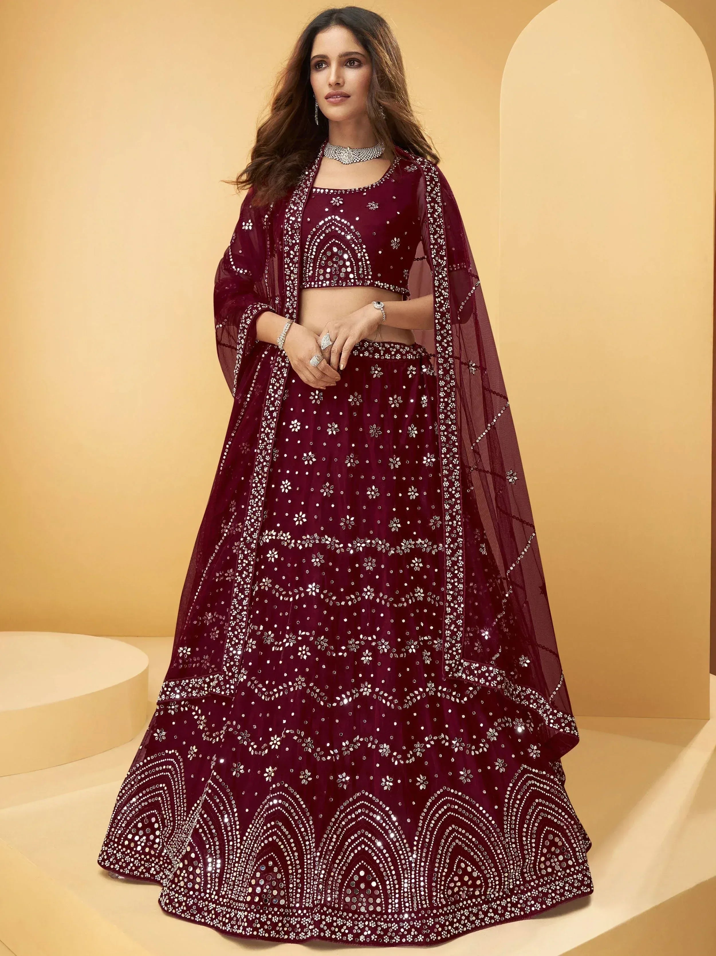 Burgundy designer lehenga choli with heavy mirror work and net dupatta, perfect for Indian ethnic occasions