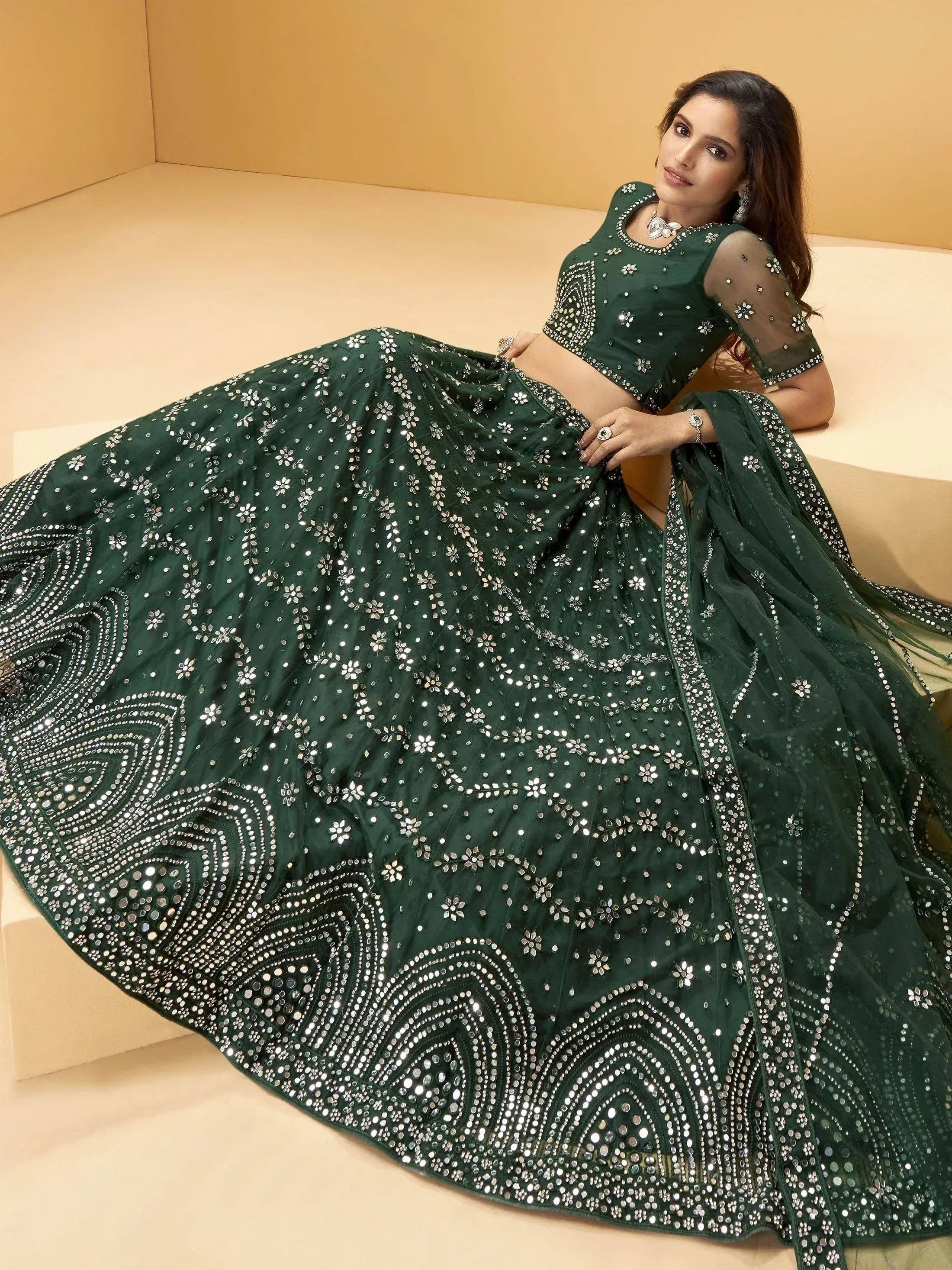 Emerald green designer lehenga choli with heavy mirror and sequin work, perfect for Indian weddings and festive occasions.