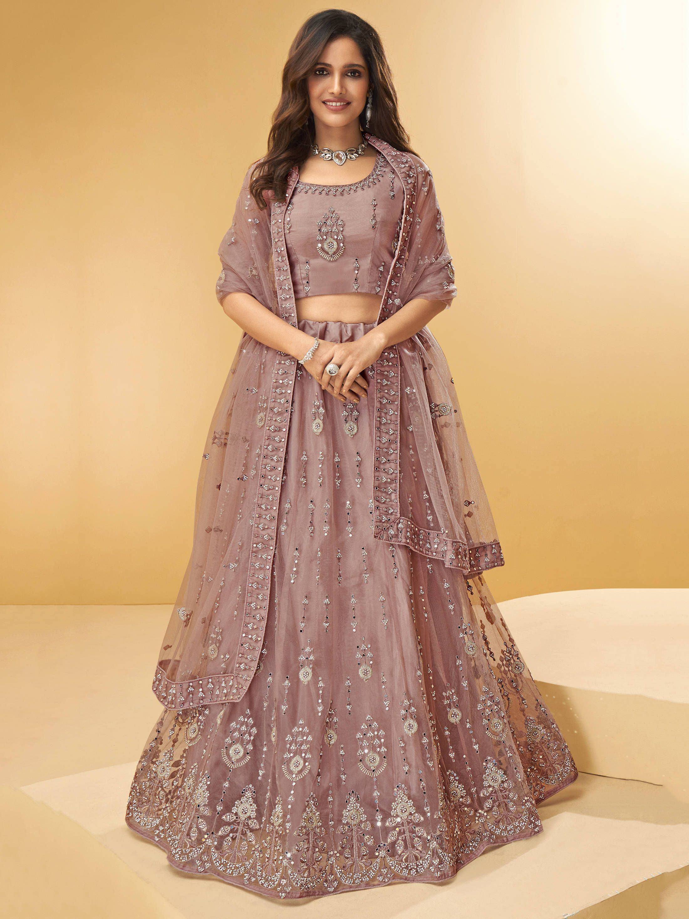 Dusty pink embroidered lehenga choli with sheer dupatta, perfect for Indian weddings and festive occasions.