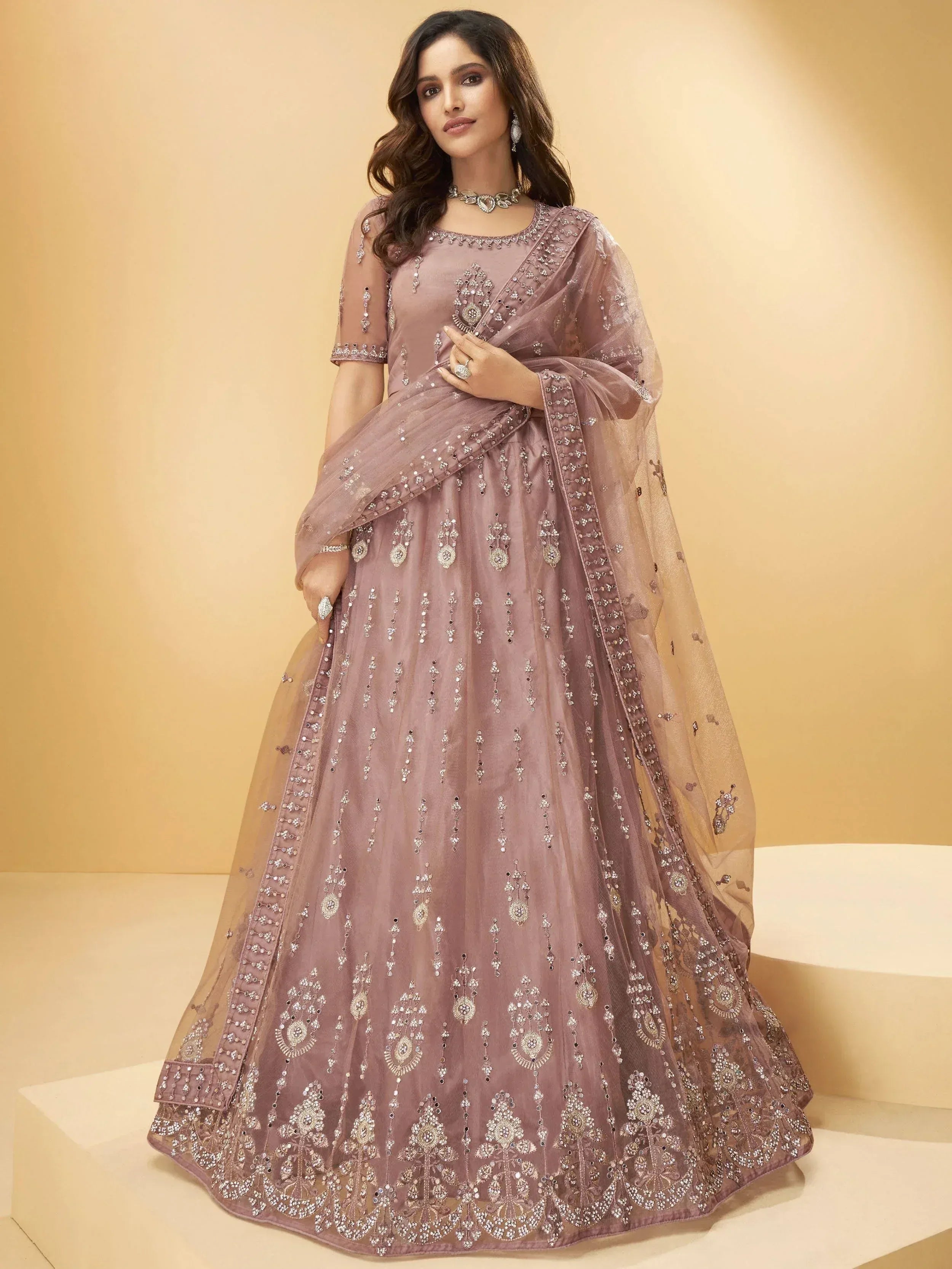 Elegant mauve designer lehenga choli with intricate embroidery and sheer dupatta for Indian ethnic wear