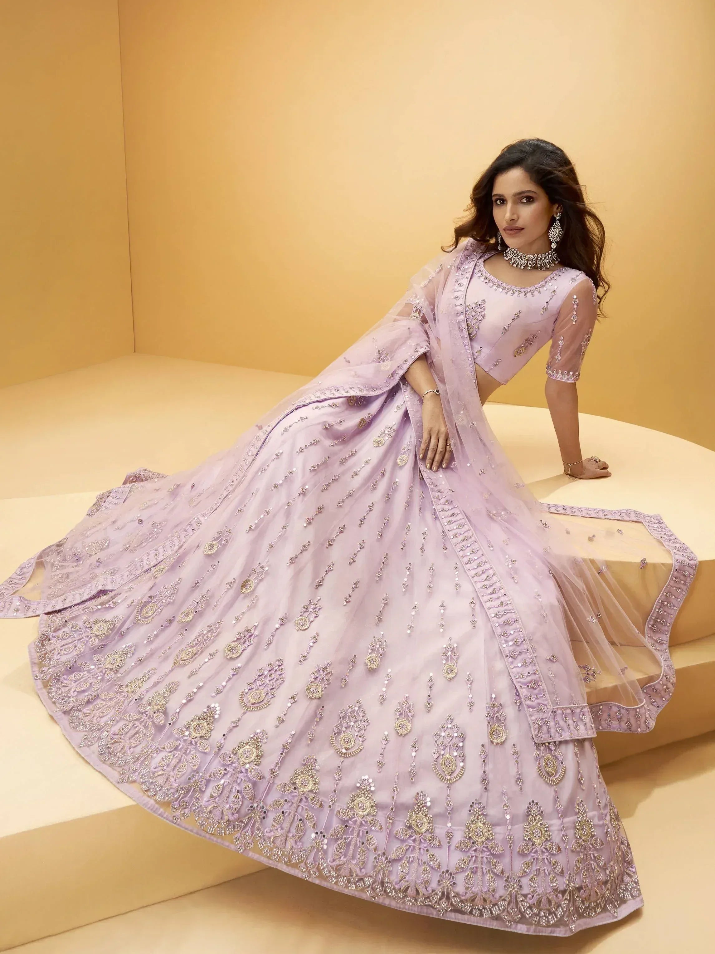 Lavender designer lehenga choli with heavy gold embroidery, perfect for Indian weddings and festive occasions.