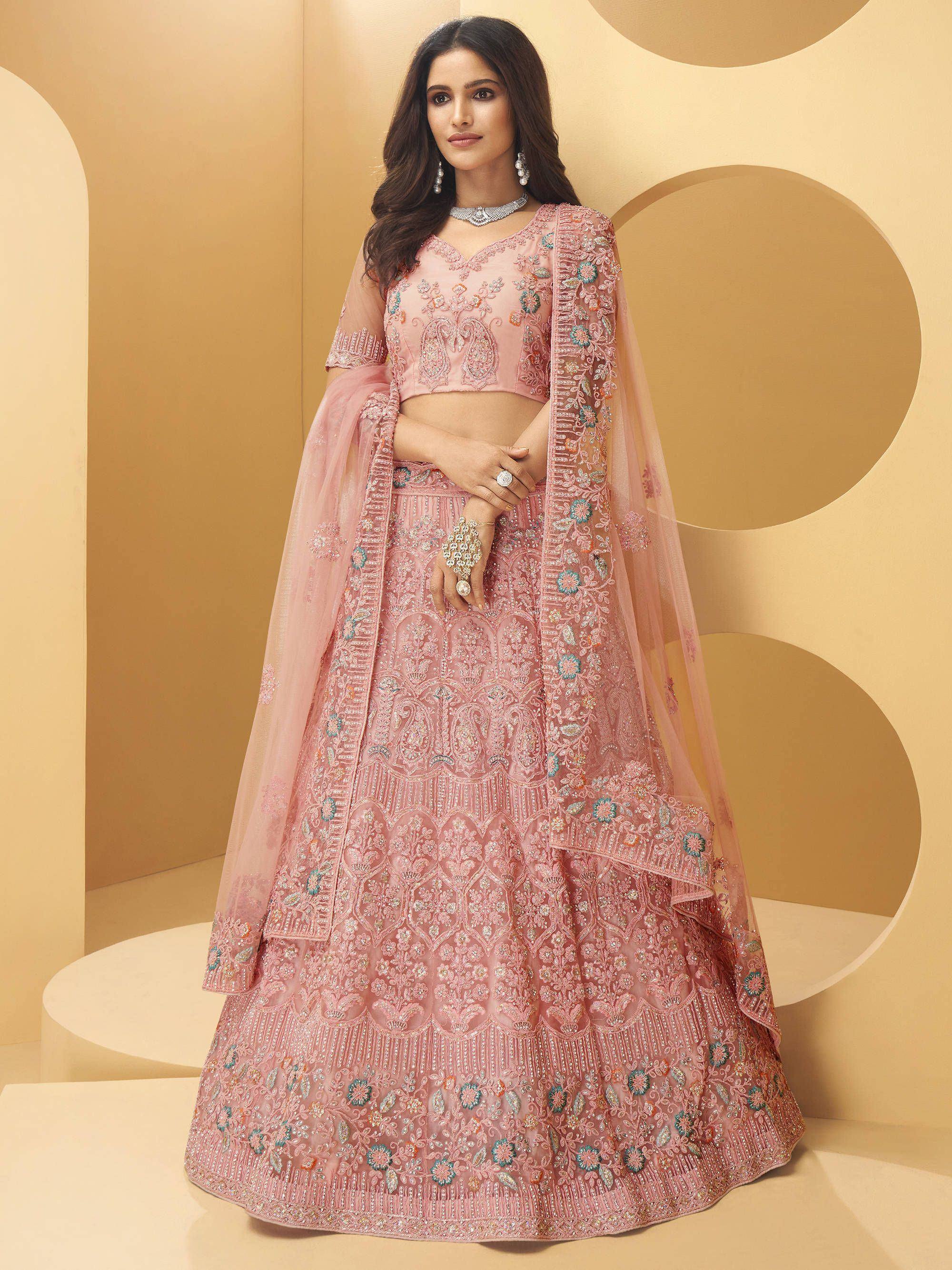 Pink embroidered lehenga choli with floral motifs and sheer dupatta, perfect for Indian weddings and festive occasions.